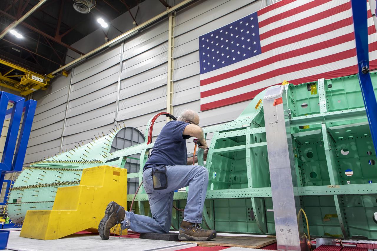 Event: SEG 210 Forebody A Lockheed Martin technician works on the ejection seat support structure and once complete, the ejection seat rails will be installed on the X-59 airplane. The aircraft, under construction at Lockheed Martin Skunk Works in Palmdale, California, will demonstrate the ability to fly supersonic while reducing the loud sonic boom to a quiet sonic thump.