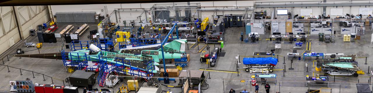 Here is an overhead view of the X-59 aircraft (left) prior to the installation of the General Electric F414 engine (center, located under the blue cover). After the engine is installed, the lower empennage (right), the last remaining major aircraft component, will be installed in preparation for integrated system checkouts. The X-59 is the centerpiece of the Quesst mission which plans to help enable commercial supersonic air travel over land. 