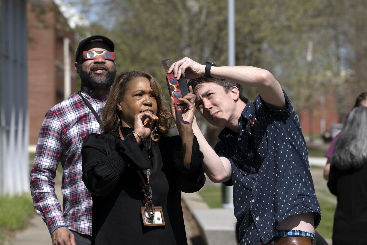 People are seen viewing the partial solar eclipse from NASA Langley Research Center in Hampton, VA, Monday, April 8, 2024. A total solar eclipse swept across a narrow portion of the North American continent from Mexico’s Pacific coast to the Atlantic coast of Newfoundland, Canada. A partial solar eclipse was visible across the entire North American continent along with parts of Central America and Europe.  Photo Credit: (NASA/Ryan Hill)