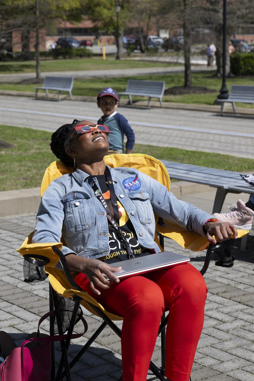 People are seen viewing the partial solar eclipse from NASA Langley Research Center in Hampton, VA, Monday, April 8, 2024. A total solar eclipse swept across a narrow portion of the North American continent from Mexico’s Pacific coast to the Atlantic coast of Newfoundland, Canada. A partial solar eclipse was visible across the entire North American continent along with parts of Central America and Europe.  Photo Credit: (NASA/Ryan Hill)