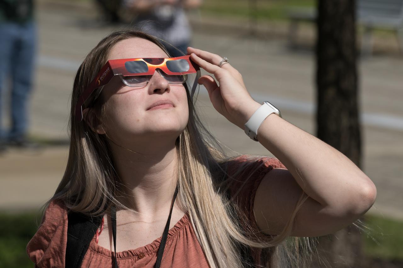 People are seen viewing the partial solar eclipse from NASA Langley Research Center in Hampton, VA, Monday, April 8, 2024. A total solar eclipse swept across a narrow portion of the North American continent from Mexico’s Pacific coast to the Atlantic coast of Newfoundland, Canada. A partial solar eclipse was visible across the entire North American continent along with parts of Central America and Europe.  Photo Credit: (NASA/Mark Knopp)