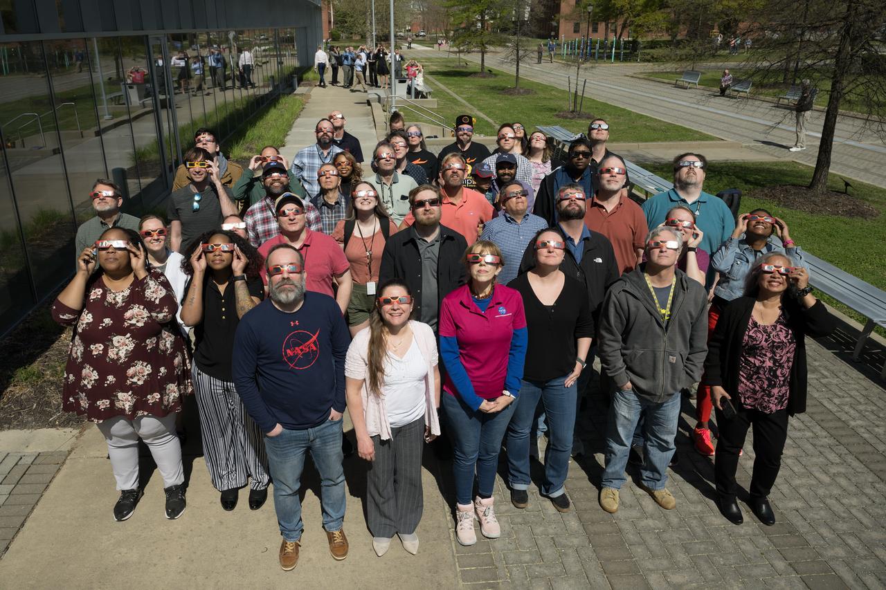 People are seen viewing the partial solar eclipse from NASA Langley Research Center in Hampton, VA, Monday, April 8, 2024. A total solar eclipse swept across a narrow portion of the North American continent from Mexico’s Pacific coast to the Atlantic coast of Newfoundland, Canada. A partial solar eclipse was visible across the entire North American continent along with parts of Central America and Europe.  Photo Credit: (NASA/Mark Knopp)