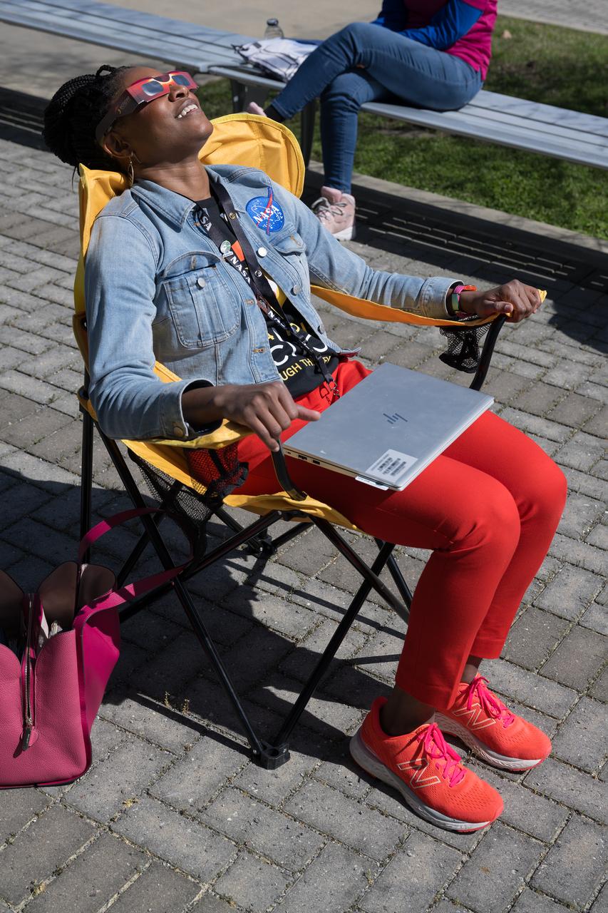 People are seen viewing the partial solar eclipse from NASA Langley Research Center in Hampton, VA, Monday, April 8, 2024. A total solar eclipse swept across a narrow portion of the North American continent from Mexico’s Pacific coast to the Atlantic coast of Newfoundland, Canada. A partial solar eclipse was visible across the entire North American continent along with parts of Central America and Europe.  Photo Credit: (NASA/Mark Knopp)