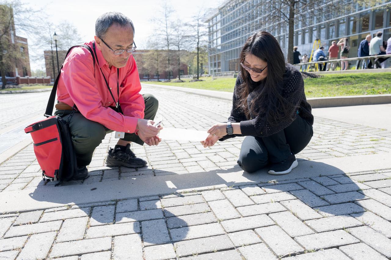 People are seen viewing the partial solar eclipse from NASA Langley Research Center in Hampton, VA, Monday, April 8, 2024. A total solar eclipse swept across a narrow portion of the North American continent from Mexico’s Pacific coast to the Atlantic coast of Newfoundland, Canada. A partial solar eclipse was visible across the entire North American continent along with parts of Central America and Europe.  Photo Credit: (NASA/Mark Knopp)