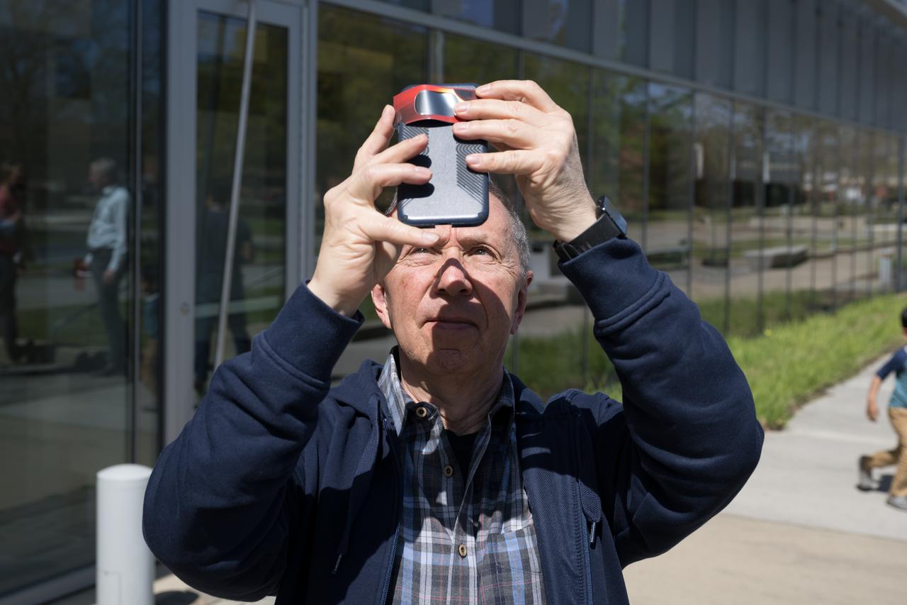 People are seen viewing the partial solar eclipse from NASA Langley Research Center in Hampton, VA, Monday, April 8, 2024. A total solar eclipse swept across a narrow portion of the North American continent from Mexico’s Pacific coast to the Atlantic coast of Newfoundland, Canada. A partial solar eclipse was visible across the entire North American continent along with parts of Central America and Europe.  Photo Credit: (NASA/Mark Knopp)