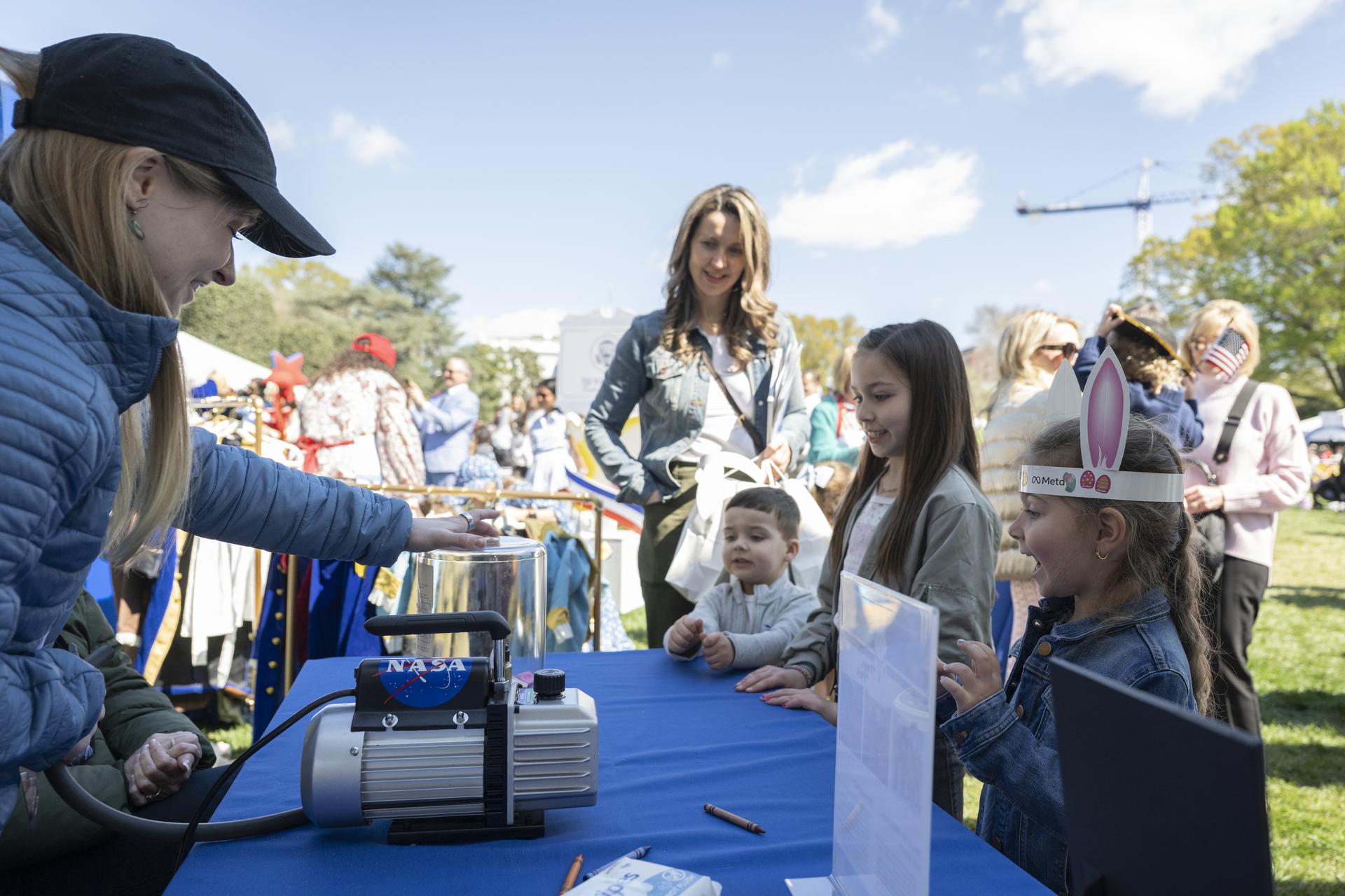 NASA Staff engage with families at the Peeps stem station during the White House Easter Egg Roll, on the South Lawn in Washington D.C., on April 6, 2026. (Photo Credit: (NASA/Crystal R. Hines)