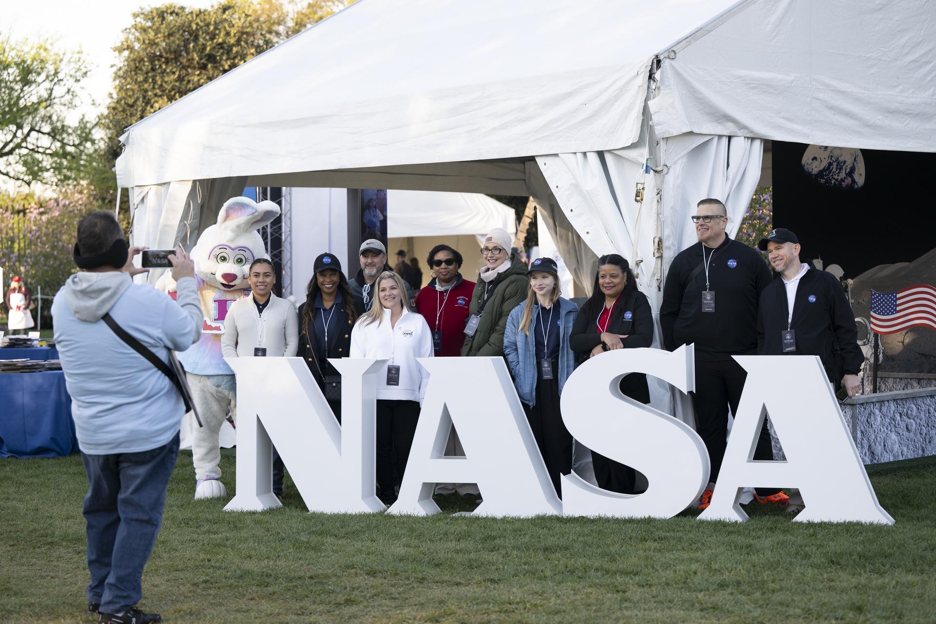 NASA staff from left to right, Keiry Martinez, Lisa Frazier, Dustin Hitt, Kathryn Gulledge, Holly Miller, Rachel Zasucha, Denise Young, Jason Smith, Brian Campbell, and Trena Ferrell pose with the Easter Bunny at the NASA Letters before the start of the White House Easter Egg Roll, on the South Lawn in Washington D.C., on April 6, 2026. (Photo Credit: (NASA/Crystal R. Hines)