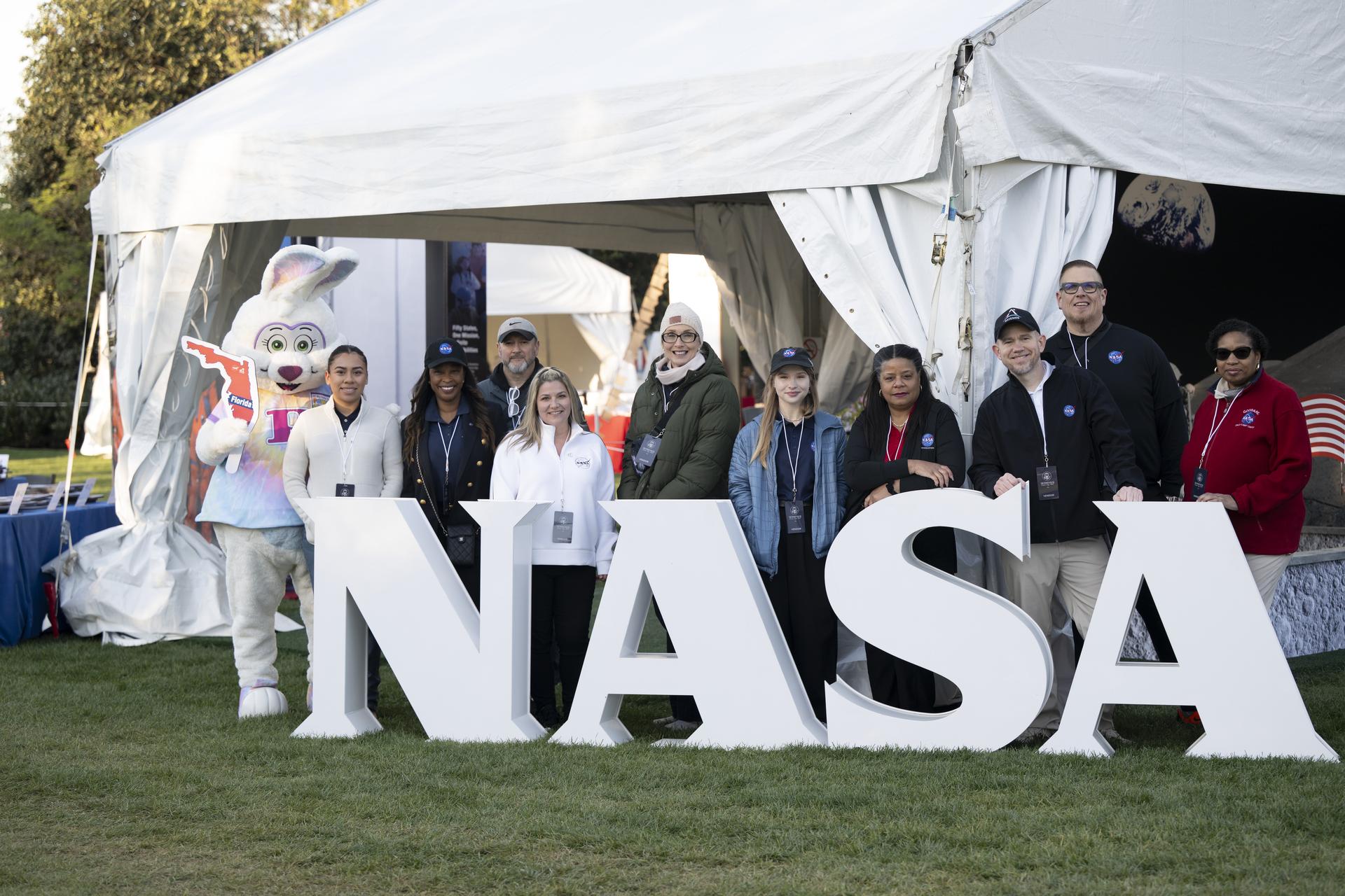 NASA staff from left to right, Keiry Martinez, Lisa Frazier, Dustin Hitt, Kathryn Gulledge, Holly Miller, Rachel Zasucha, Denise Young, Jason Smith, Brian Campbell, and Trena Ferrell pose with the Easter Bunny at the NASA Letters before the start of the White House Easter Egg Roll, on the South Lawn in Washington D.C., on April 6, 2026. (Photo Credit: (NASA/Crystal R. Hines)