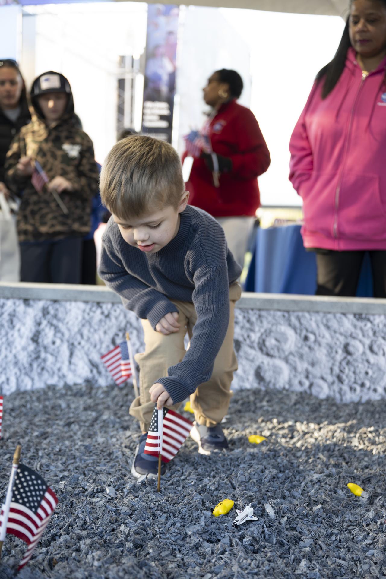 Child explore the NASA Moon Box (Lunar Sandbox) digging for “moon rocks” and planting an American flag, to bringing Artemis exploration to life through curiosity and engagement. during the White House Easter Egg Roll, on the South Lawn in Washington D.C., on April 6, 2026. (Photo Credit: (NASA/Crystal R. Hines)