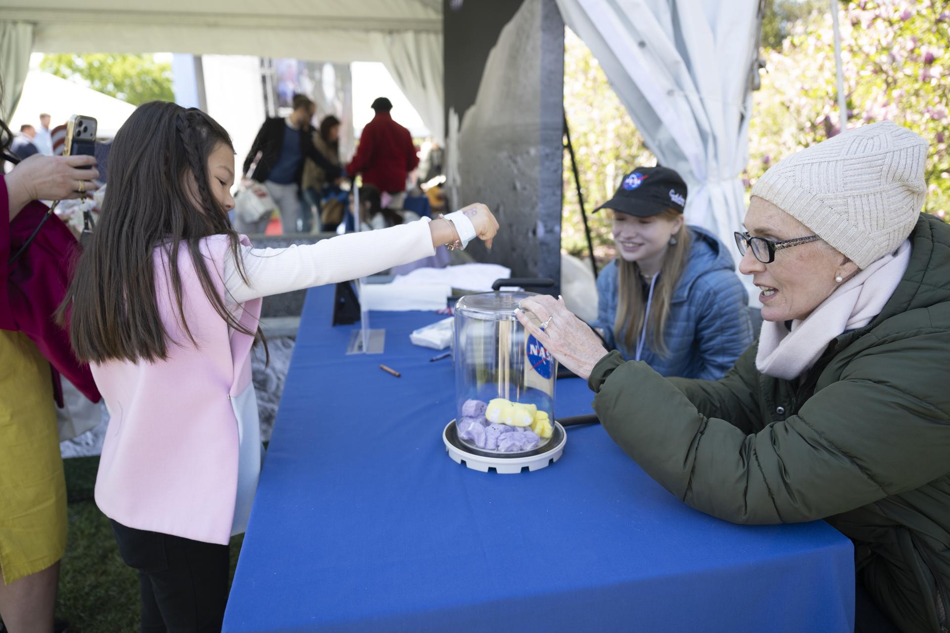 NASA Staff engage with families at the Peeps stem station during the White House Easter Egg Roll, on the South Lawn in Washington D.C., on April 6, 2026. (Photo Credit: (NASA/Crystal R. Hines)