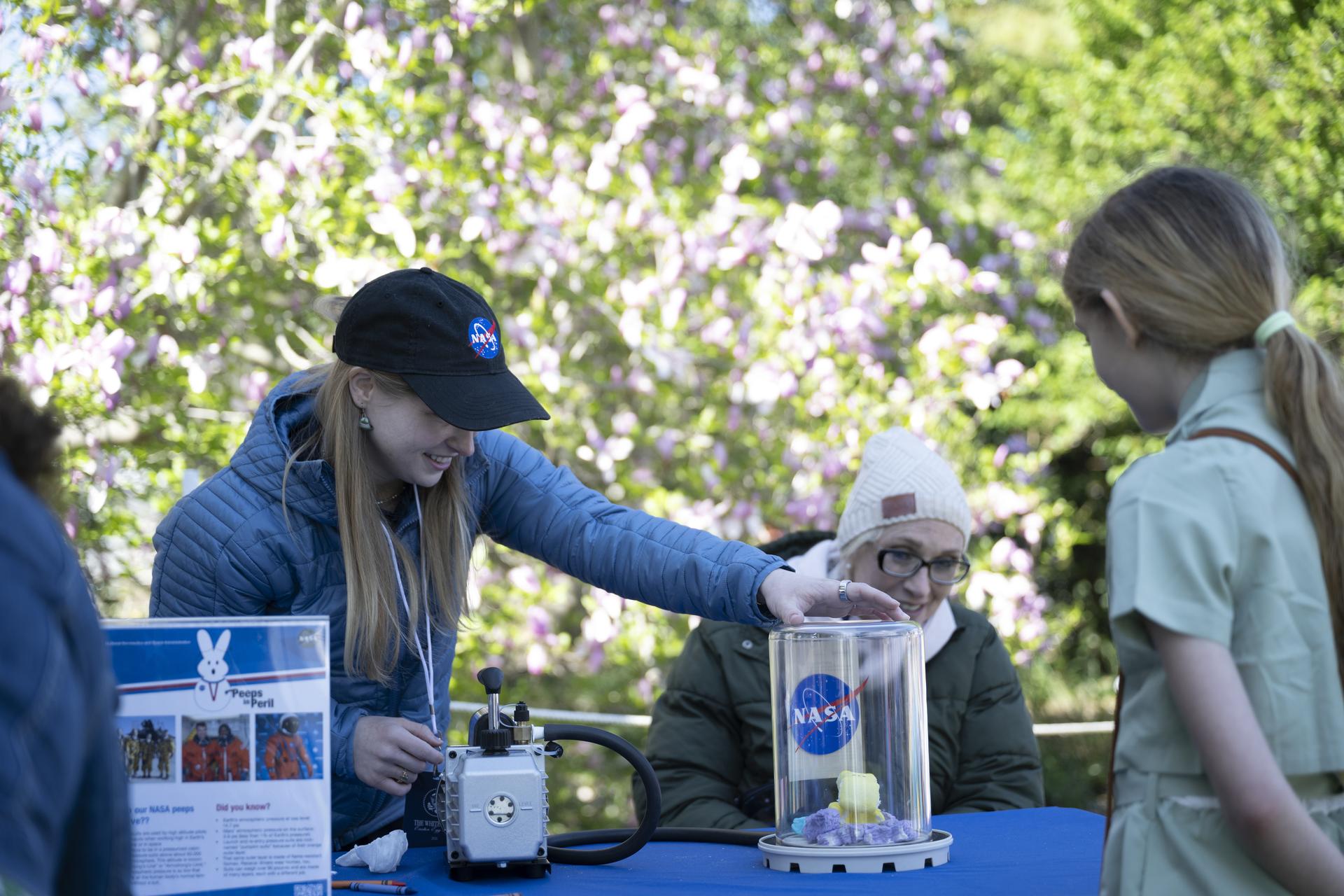 NASA Staff engage with families at the Peeps stem station during the White House Easter Egg Roll, on the South Lawn in Washington D.C., on April 6, 2026. (Photo Credit: (NASA/Crystal R. Hines)
