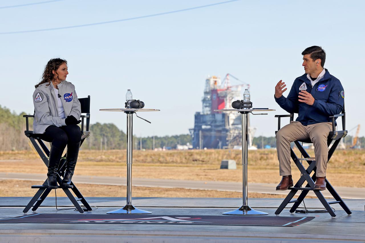 Host Leigh D’Angelo (left) talks with NASA Space Launch System core stage engineer Alex Cagnola from Michoud Assembly Facility in New Orleans, during NASA TV live coverage from Stennis Space Center near Bay St. Louis, Mississippi, on Jan. 16, 2021. D’Angelo, also from Michoud Assembly Facility, hosted the NASA TV coverage prior to the hot fire test of the core stage for the agency’s Space Launch System rocket. The hot fire test of the stage’s four RS-25 engines generated a combined 1.6 million pounds of thrust, just as will occur during an actual launch. The hot fire is the final test of the Green Run test series, a comprehensive assessment of the SLS core stage prior to launching the Artemis I mission to the Moon.