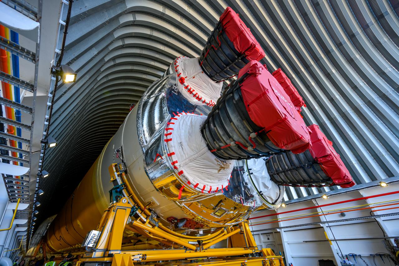 These images show the first core stage for NASA’s Space Launch System rocket inside NASA’s Pegasus barge on Jan. 8 ahead of its forthcoming journey to NASA’s Stennis Space Center near Bay St. Louis, Mississippi. Teams rolled out, or moved, the completed core stage from NASA’s Michoud Assembly Facility in New Orleans to the barge in preparation for the SLS rocket’s core stage Green Run test series at Stennis. Pegasus, which was modified to ferry SLS rocket hardware, will transport the core stage more than 40 miles from Michoud to Stennis for the comprehensive core stage Green Run test series. Green Run, named for its testing of new, or green, hardware progressively is the final test campaign ahead of the first Artemis launch.  Assembly and integration of the core stage and its four RS-25 engines has been a collaborative, multistep process for NASA and its partners Boeing, the core stage lead contractor, and Aerojet Rocketdyne, the RS-25 engines lead contractor. Together with four RS-25 engines, the rocket’s massive 212-foot-tall core stage — the largest stage NASA has ever built — and its twin solid rocket boosters will produce 8.8 million pounds of thrust to send NASA’s Orion spacecraft, astronauts and supplies beyond Earth’s orbit to the Moon and, ultimately, Mars. Offering more payload mass, volume capability and energy to speed missions through space, the SLS rocket, along with NASA’s Gateway in lunar orbit and Orion, is part of NASA’s backbone for deep space exploration and the Artemis lunar program. 