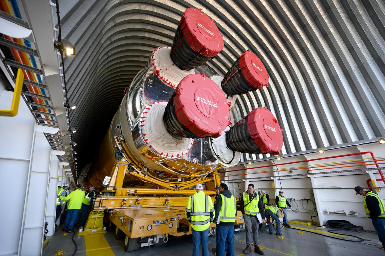 These images show the first core stage for NASA’s Space Launch System rocket inside NASA’s Pegasus barge on Jan. 8 ahead of its forthcoming journey to NASA’s Stennis Space Center near Bay St. Louis, Mississippi. Teams rolled out, or moved, the completed core stage from NASA’s Michoud Assembly Facility in New Orleans to the barge in preparation for the SLS rocket’s core stage Green Run test series at Stennis. Pegasus, which was modified to ferry SLS rocket hardware, will transport the core stage more than 40 miles from Michoud to Stennis for the comprehensive core stage Green Run test series. Green Run, named for its testing of new, or green, hardware progressively is the final test campaign ahead of the first Artemis launch.  Assembly and integration of the core stage and its four RS-25 engines has been a collaborative, multistep process for NASA and its partners Boeing, the core stage lead contractor, and Aerojet Rocketdyne, the RS-25 engines lead contractor. Together with four RS-25 engines, the rocket’s massive 212-foot-tall core stage — the largest stage NASA has ever built — and its twin solid rocket boosters will produce 8.8 million pounds of thrust to send NASA’s Orion spacecraft, astronauts and supplies beyond Earth’s orbit to the Moon and, ultimately, Mars. Offering more payload mass, volume capability and energy to speed missions through space, the SLS rocket, along with NASA’s Gateway in lunar orbit and Orion, is part of NASA’s backbone for deep space exploration and the Artemis lunar program. 