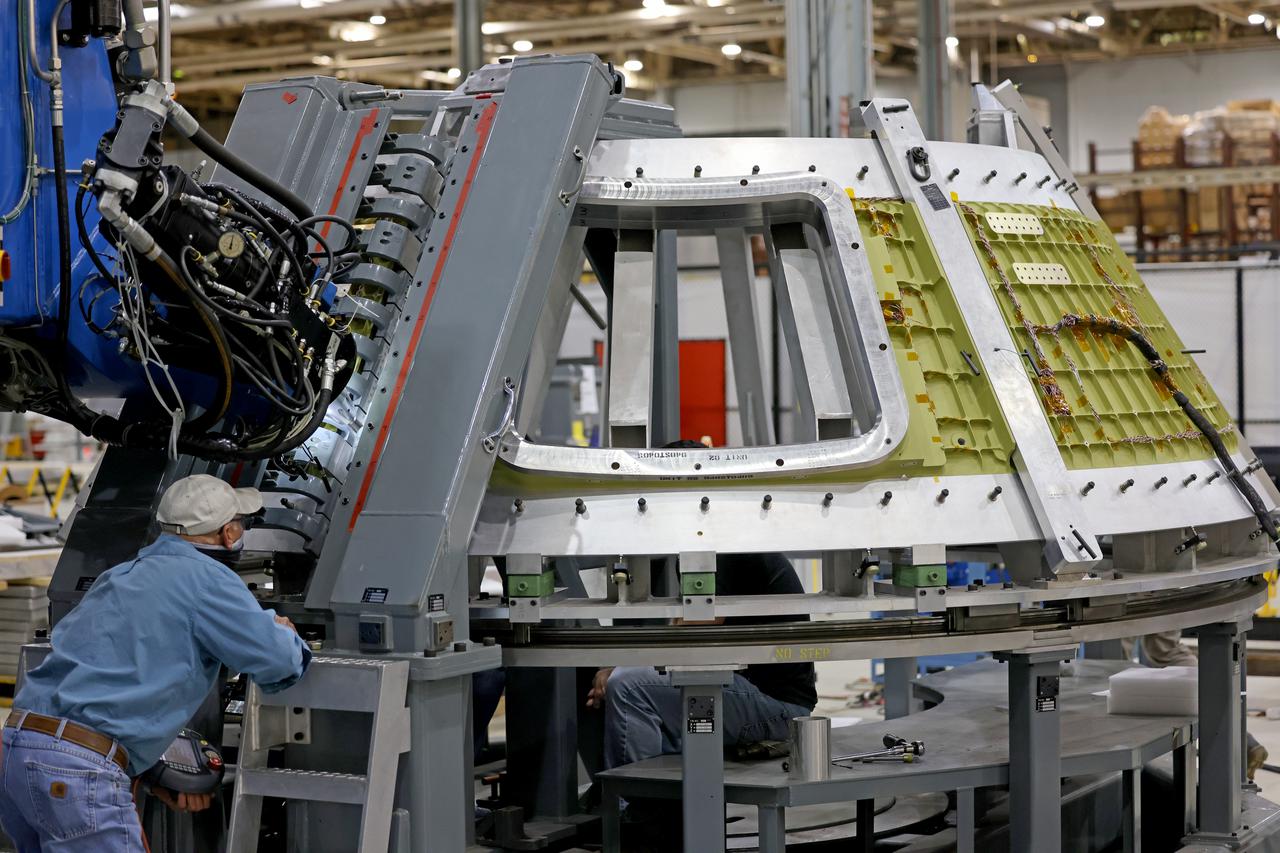 At NASA’s Michoud Assembly Facility in New Orleans, technicians from Orion prime contractor Lockheed Martin have welded together three cone-shaped panels on Orion’s crew module for the Artemis III mission that will land the first woman and next man on the Moon.  The crew module’s primary structure, the pressure vessel, is comprised of seven machined aluminum alloy pieces that are welded together through a weld process that produces a strong, air-tight habitable space for astronauts during the mission. The pressure vessel is designed to withstand the harsh and demanding environment of deep space, and is the core structure upon which all the other elements of Orion’s crew module are integrated.  Infographic showing the seven pieces of Orion's underlying structure  With welding complete on the crew module cone panels – one of which contains windows providing astronauts views of the Moon and Earth – work will begin joining the forward bulkhead to the tunnel to create the top of the spacecraft, followed by the barrel and aft bulkhead join to form the bottom of Orion.  Last, the forward bulkhead will be welded to the top of the panels and, for the seventh and closeout weld, the bottom of the cone panels will be joined to the barrel to complete the pressure vessel. Once welding of the Artemis III crew module primary structure is complete, it will be shipped to NASA’s Kennedy Space Center in Florida where it will undergo further assembly beginning this fall.  Orion, the Space Launch System, and Exploration Ground Systems programs are foundational elements of the Artemis program. Artemis I will be the first integrated flight test of Orion and SLS and is targeted to launch later this year. Artemis II will follow and is the first crewed mission, taking humans farther into space than ever before. Image credit: NASA/Michael DeMocker
