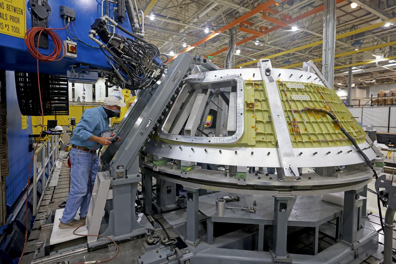 At NASA’s Michoud Assembly Facility in New Orleans, technicians from Orion prime contractor Lockheed Martin have welded together three cone-shaped panels on Orion’s crew module for the Artemis III mission that will land the first woman and next man on the Moon.  The crew module’s primary structure, the pressure vessel, is comprised of seven machined aluminum alloy pieces that are welded together through a weld process that produces a strong, air-tight habitable space for astronauts during the mission. The pressure vessel is designed to withstand the harsh and demanding environment of deep space, and is the core structure upon which all the other elements of Orion’s crew module are integrated.  Infographic showing the seven pieces of Orion's underlying structure  With welding complete on the crew module cone panels – one of which contains windows providing astronauts views of the Moon and Earth – work will begin joining the forward bulkhead to the tunnel to create the top of the spacecraft, followed by the barrel and aft bulkhead join to form the bottom of Orion.  Last, the forward bulkhead will be welded to the top of the panels and, for the seventh and closeout weld, the bottom of the cone panels will be joined to the barrel to complete the pressure vessel. Once welding of the Artemis III crew module primary structure is complete, it will be shipped to NASA’s Kennedy Space Center in Florida where it will undergo further assembly beginning this fall.  Orion, the Space Launch System, and Exploration Ground Systems programs are foundational elements of the Artemis program. Artemis I will be the first integrated flight test of Orion and SLS and is targeted to launch later this year. Artemis II will follow and is the first crewed mission, taking humans farther into space than ever before. Image credit: NASA/Michael DeMocker