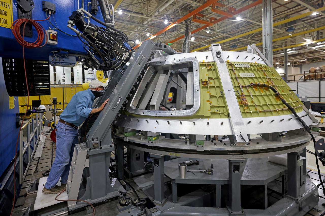 At NASA’s Michoud Assembly Facility in New Orleans, technicians from Orion prime contractor Lockheed Martin have welded together three cone-shaped panels on Orion’s crew module for the Artemis III mission that will land the first woman and next man on the Moon.  The crew module’s primary structure, the pressure vessel, is comprised of seven machined aluminum alloy pieces that are welded together through a weld process that produces a strong, air-tight habitable space for astronauts during the mission. The pressure vessel is designed to withstand the harsh and demanding environment of deep space, and is the core structure upon which all the other elements of Orion’s crew module are integrated.  Infographic showing the seven pieces of Orion's underlying structure  With welding complete on the crew module cone panels – one of which contains windows providing astronauts views of the Moon and Earth – work will begin joining the forward bulkhead to the tunnel to create the top of the spacecraft, followed by the barrel and aft bulkhead join to form the bottom of Orion.  Last, the forward bulkhead will be welded to the top of the panels and, for the seventh and closeout weld, the bottom of the cone panels will be joined to the barrel to complete the pressure vessel. Once welding of the Artemis III crew module primary structure is complete, it will be shipped to NASA’s Kennedy Space Center in Florida where it will undergo further assembly beginning this fall.  Orion, the Space Launch System, and Exploration Ground Systems programs are foundational elements of the Artemis program. Artemis I will be the first integrated flight test of Orion and SLS and is targeted to launch later this year. Artemis II will follow and is the first crewed mission, taking humans farther into space than ever before. Image credit: NASA/Michael DeMocker