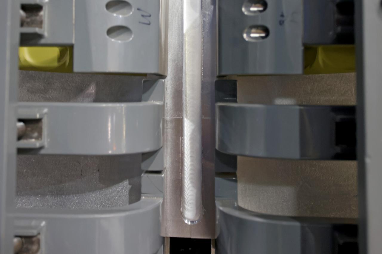 At NASA’s Michoud Assembly Facility in New Orleans, technicians from Orion prime contractor Lockheed Martin have welded together three cone-shaped panels on Orion’s crew module for the Artemis III mission that will land the first woman and next man on the Moon.  The crew module’s primary structure, the pressure vessel, is comprised of seven machined aluminum alloy pieces that are welded together through a weld process that produces a strong, air-tight habitable space for astronauts during the mission. The pressure vessel is designed to withstand the harsh and demanding environment of deep space, and is the core structure upon which all the other elements of Orion’s crew module are integrated.  Infographic showing the seven pieces of Orion's underlying structure  With welding complete on the crew module cone panels – one of which contains windows providing astronauts views of the Moon and Earth – work will begin joining the forward bulkhead to the tunnel to create the top of the spacecraft, followed by the barrel and aft bulkhead join to form the bottom of Orion.  Last, the forward bulkhead will be welded to the top of the panels and, for the seventh and closeout weld, the bottom of the cone panels will be joined to the barrel to complete the pressure vessel. Once welding of the Artemis III crew module primary structure is complete, it will be shipped to NASA’s Kennedy Space Center in Florida where it will undergo further assembly beginning this fall.  Orion, the Space Launch System, and Exploration Ground Systems programs are foundational elements of the Artemis program. Artemis I will be the first integrated flight test of Orion and SLS and is targeted to launch later this year. Artemis II will follow and is the first crewed mission, taking humans farther into space than ever before. Image credit: NASA/Michael DeMocker