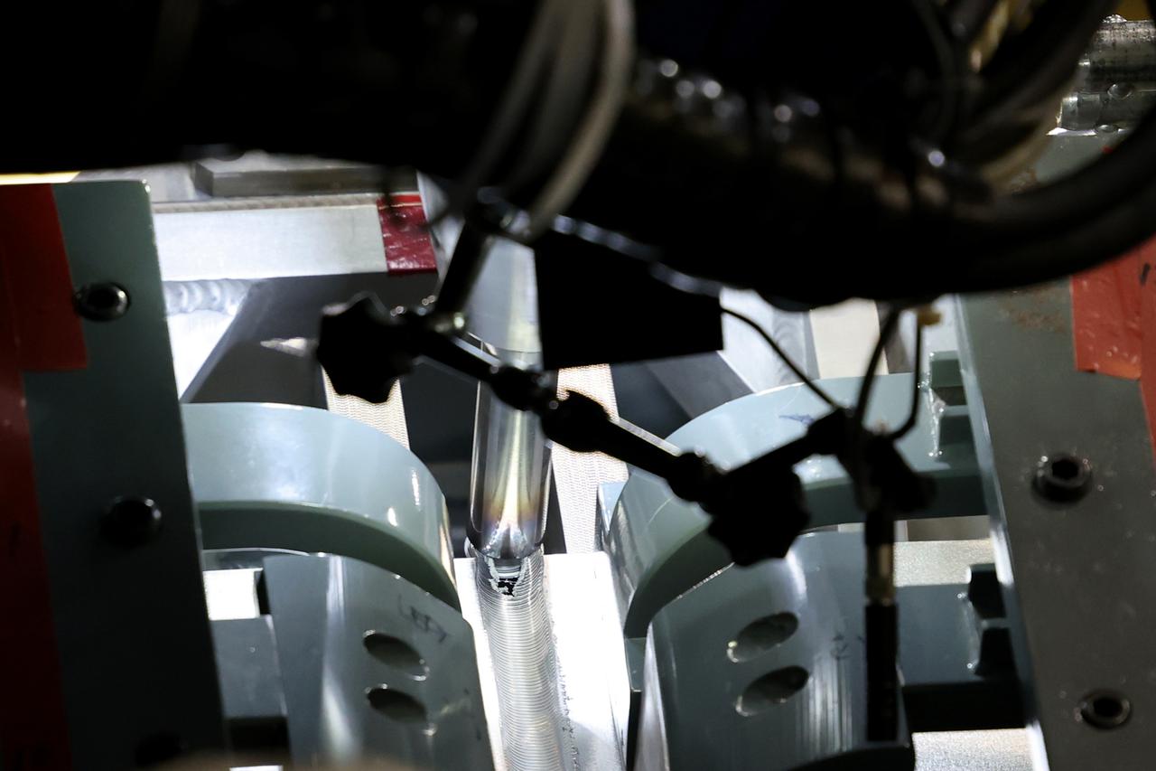 At NASA’s Michoud Assembly Facility in New Orleans, technicians from Orion prime contractor Lockheed Martin have welded together three cone-shaped panels on Orion’s crew module for the Artemis III mission that will land the first woman and next man on the Moon.  The crew module’s primary structure, the pressure vessel, is comprised of seven machined aluminum alloy pieces that are welded together through a weld process that produces a strong, air-tight habitable space for astronauts during the mission. The pressure vessel is designed to withstand the harsh and demanding environment of deep space, and is the core structure upon which all the other elements of Orion’s crew module are integrated.  Infographic showing the seven pieces of Orion's underlying structure  With welding complete on the crew module cone panels – one of which contains windows providing astronauts views of the Moon and Earth – work will begin joining the forward bulkhead to the tunnel to create the top of the spacecraft, followed by the barrel and aft bulkhead join to form the bottom of Orion.  Last, the forward bulkhead will be welded to the top of the panels and, for the seventh and closeout weld, the bottom of the cone panels will be joined to the barrel to complete the pressure vessel. Once welding of the Artemis III crew module primary structure is complete, it will be shipped to NASA’s Kennedy Space Center in Florida where it will undergo further assembly beginning this fall.  Orion, the Space Launch System, and Exploration Ground Systems programs are foundational elements of the Artemis program. Artemis I will be the first integrated flight test of Orion and SLS and is targeted to launch later this year. Artemis II will follow and is the first crewed mission, taking humans farther into space than ever before. Image credit: NASA/Michael DeMocker