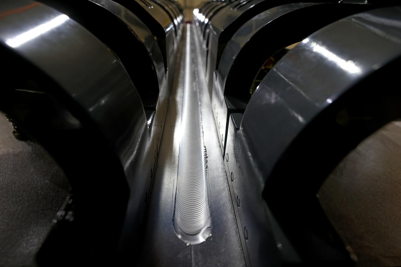 At NASA’s Michoud Assembly Facility in New Orleans, technicians from Orion prime contractor Lockheed Martin have welded together three cone-shaped panels on Orion’s crew module for the Artemis III mission that will land the first woman and next man on the Moon.  The crew module’s primary structure, the pressure vessel, is comprised of seven machined aluminum alloy pieces that are welded together through a weld process that produces a strong, air-tight habitable space for astronauts during the mission. The pressure vessel is designed to withstand the harsh and demanding environment of deep space, and is the core structure upon which all the other elements of Orion’s crew module are integrated.  Infographic showing the seven pieces of Orion's underlying structure  With welding complete on the crew module cone panels – one of which contains windows providing astronauts views of the Moon and Earth – work will begin joining the forward bulkhead to the tunnel to create the top of the spacecraft, followed by the barrel and aft bulkhead join to form the bottom of Orion.  Last, the forward bulkhead will be welded to the top of the panels and, for the seventh and closeout weld, the bottom of the cone panels will be joined to the barrel to complete the pressure vessel. Once welding of the Artemis III crew module primary structure is complete, it will be shipped to NASA’s Kennedy Space Center in Florida where it will undergo further assembly beginning this fall.  Orion, the Space Launch System, and Exploration Ground Systems programs are foundational elements of the Artemis program. Artemis I will be the first integrated flight test of Orion and SLS and is targeted to launch later this year. Artemis II will follow and is the first crewed mission, taking humans farther into space than ever before. Image credit: NASA/Michael DeMocker