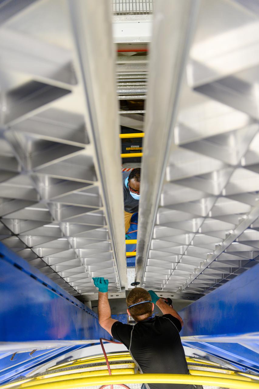 Technicians are manufacturing and testing the first in a series of initial weld confidence articles for the Exploration Upper Stage (EUS) for future flights of NASA’s Space Launch System (SLS) rocket at the agency’s Michoud Assembly Facility in New Orleans. The Exploration Upper Stage will be used on the second configuration of the SLS rocket, known as Block 1B, and will provide in-space propulsion to send astronauts in NASA’s Orion spacecraft and heavy cargo on a precise trajectory to the Moon. The Exploration Upper Stage weld confidence panels are first produced in the Vertical Weld Center at Michoud, then small sections of the panels are removed for mechanical testing and analysis in another area of the factory. Teams use weld confidence articles to verify welding procedures, interfaces between the tooling and hardware, and the structural integrity of the welds. Testing of the EUS weld confidence articles will help engineers and technicians validate welding parameters for manufacturing EUS hardware.  The first three SLS flights of NASA’s Artemis program will use an interim cryogenic propulsion stage with one RL10 engine to send Orion to the Moon. The SLS Exploration Upper Stage for flights beyond Artemis III has larger propellant tanks and four RL10 engines. The evolution of the rocket to SLS Block 1B configuration with EUS enables SLS to launch 40% more cargo to the Moon along with the crew. Manufacturing the Exploration Upper Stage is a collaborative effort between NASA and Boeing, the lead contractor for EUS and the SLS core stage.  SLS is the only rocket that can send Orion, astronauts, and supplies to the Moon in a single mission. The SLS rocket, NASA’s Orion spacecraft, Gateway, and human landing system are part of NASA’s backbone for deep space exploration. Under the Artemis program, NASA is working to land the first woman and the next man on the Moon to pave the way for sustainable exploration at the Moon and future missions to Mars. (NASA)
