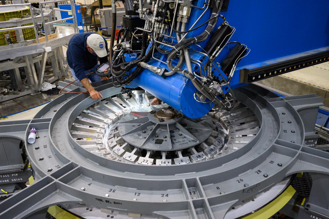 Technicians from Orion Prime Contractor Lockheed Martin weld the forward bulkhead of the pressure vessel to the tunnel hardware on the Orion Spacecraft for the Artemis III mission at NASA’s Michoud Assembly Facility in New Orleans. The crew module’s primary structure, the pressure vessel, is comprised of seven machined aluminum alloy pieces that are welded together through a weld process that produces a strong, air-tight habitable space for astronauts during the mission. The pressure vessel is designed to withstand the harsh and demanding environment of deep space and is the core structure upon which all the other elements of Orion’s crew module are integrated.  This pressure vessel weld is the next step following the completion of the crew module cone panel welds and creates the top of the spacecraft. Work will then begin to join the barrel with the aft bulkhead to form the bottom of Orion. Last, the forward bulkhead will be welded to the top of the panels and, for the seventh and closeout weld, the bottom of the cone panels will be joined to the barrel to complete the pressure vessel.  Once welding of the Artemis III crew module primary structure is complete, it will be shipped to NASA’s Kennedy Space Center in Florida where it will undergo further assembly beginning this fall. Orion, the Space Launch System, and Exploration Ground Systems programs are foundational elements of the Artemis program. Artemis I will be the first integrated flight test of Orion and SLS and is targeted to launch later this year. Artemis II will follow and is the first crewed mission, taking humans farther into space than ever before. 