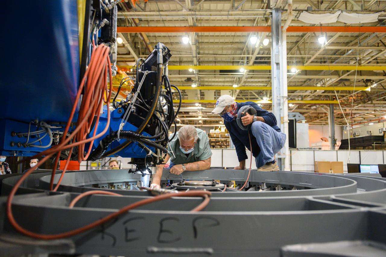 Technicians from Orion Prime Contractor Lockheed Martin weld the forward bulkhead of the pressure vessel to the tunnel hardware on the Orion Spacecraft for the Artemis III mission at NASA’s Michoud Assembly Facility in New Orleans. The crew module’s primary structure, the pressure vessel, is comprised of seven machined aluminum alloy pieces that are welded together through a weld process that produces a strong, air-tight habitable space for astronauts during the mission. The pressure vessel is designed to withstand the harsh and demanding environment of deep space and is the core structure upon which all the other elements of Orion’s crew module are integrated.  This pressure vessel weld is the next step following the completion of the crew module cone panel welds and creates the top of the spacecraft. Work will then begin to join the barrel with the aft bulkhead to form the bottom of Orion. Last, the forward bulkhead will be welded to the top of the panels and, for the seventh and closeout weld, the bottom of the cone panels will be joined to the barrel to complete the pressure vessel.  Once welding of the Artemis III crew module primary structure is complete, it will be shipped to NASA’s Kennedy Space Center in Florida where it will undergo further assembly beginning this fall. Orion, the Space Launch System, and Exploration Ground Systems programs are foundational elements of the Artemis program. Artemis I will be the first integrated flight test of Orion and SLS and is targeted to launch later this year. Artemis II will follow and is the first crewed mission, taking humans farther into space than ever before. 