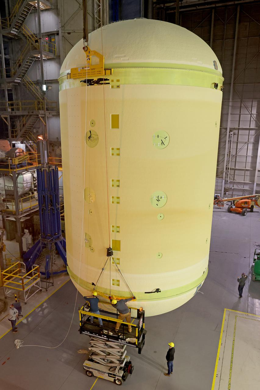 This image highlights the liquid oxygen tank, which will be used on the core stage of NASA’ Space Launch System rocket for Artemis II, the first crewed mission of NASA’s Artemis program, at NASA’s Michoud Assembly Facility. The SLS core stage is made up of five unique elements: the forward skirt, liquid oxygen tank, intertank, liquid hydrogen tank, and the engine section. The forward skirt houses flight computers, cameras, and avionics systems. The liquid oxygen tank holds 196,000 gallons of liquid oxygen cooled to minus 297 degrees Fahrenheit. The LOX hardware sits between the core stage’s forward skirt and the intertank. Along with the liquid hydrogen tank, it will provide fuel to the four RS-25 engines at the bottom of the core stage to produce more than two million pounds of thrust to launch NASA’s Artemis missions to the Moon.     Together with its four RS-25 engines, the rocket’s massive 212-foot-tall core stage — the largest stage NASA has ever built — and its twin solid rocket boosters will produce 8.8 million pounds of thrust to send NASA’s Orion spacecraft, astronauts and supplies beyond Earth’s orbit to the Moon and, ultimately, Mars. Offering more payload mass, volume capability and energy to speed missions through space, the SLS rocket, along with NASA’s Gateway in lunar orbit, the Human Landing System, and Orion spacecraft, is part of NASA’s backbone for deep space exploration and the Artemis lunar program. No other rocket can send astronauts in Orion around the Moon in a single mission. Image credit: NASA/Michael DeMocker 