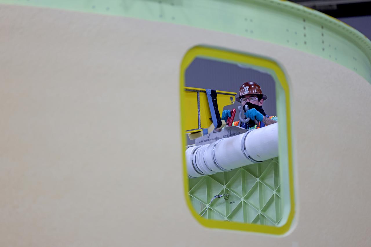 This image shows the forward skirt that will be used on the core stage of NASA’s Space Launch System rocket for Artemis II, the first crewed mission of NASA’s Artemis program, at NASA’s Michoud Assembly Facility. The SLS core stage is made up of five unique elements: the forward skirt, liquid oxygen tank, intertank, liquid hydrogen tank, and the engine section. The forward skirt houses flight computers, cameras, and avionics systems. The hardware is located at the top of the 212-foot-tall core stage and connects the upper part of the rocket to the core stage. Soon, technicians will ready the forward skirt for the first of three core stage assembly mates called the forward join. The forward join consists of three main parts -- the forward skirt, liquid oxygen tank, and intertank – to create the top, or forward part, of the core stage.  Together with its four RS-25 engines, the rocket’s massive 212-foot-tall core stage — the largest stage NASA has ever built — and its twin solid rocket boosters will produce 8.8 million pounds of thrust to send NASA’s Orion spacecraft, astronauts and supplies beyond Earth’s orbit to the Moon and, ultimately, Mars. Offering more payload mass, volume capability and energy to speed missions through space, the SLS rocket, along with NASA’s Gateway in lunar orbit, the human landing system, and Orion spacecraft, is part of NASA’s backbone for deep space exploration and the Artemis lunar program. No other rocket is capable of carrying astronauts in Orion around the Moon in a single mission. Image credit: NASA/Michael DeMocker 