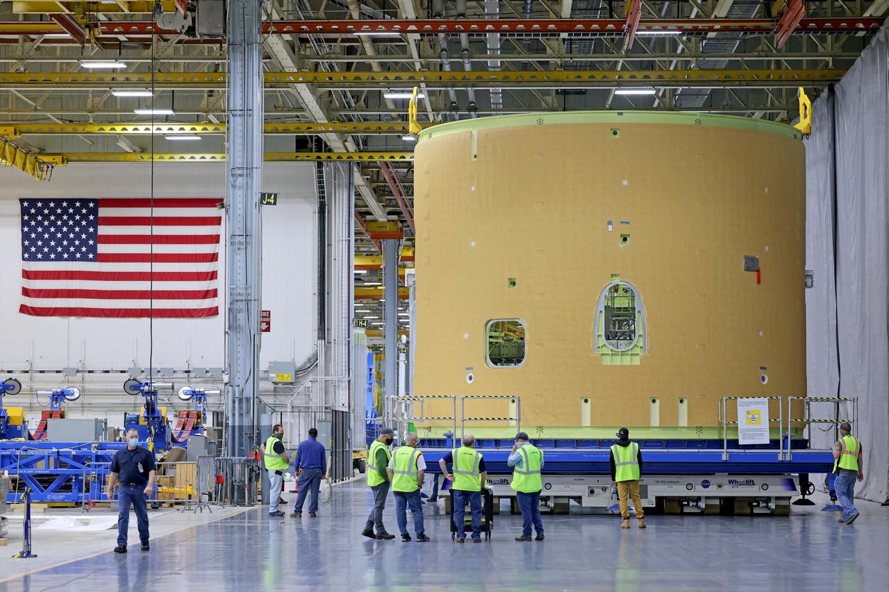This image shows technicians and engineers beginning the process of the forward join on the core stage of NASA’s Space Launch System rocket for Artemis II, the first crewed mission of NASA’s Artemis program at NASA’s Michoud Assembly Facility. The forward join connects the forward skirt, the liquid oxygen tank (LOX) and the intertank structures to form the top part of the SLS rocket’s core stage. Now, NASA and Boeing, the SLS prime contractor, will continue to integrate various systems inside the forward part of the core stage and prepare for structural joining of the liquid hydrogen tank and engine section to form the bottom of the stage.  Together with its four RS-25 engines, the rocket’s massive 212-foot-tall core stage — the largest stage NASA has ever built — and its twin solid rocket boosters will produce 8.8 million pounds of thrust to send NASA’s Orion spacecraft, astronauts and supplies beyond Earth’s orbit to the Moon and, ultimately, Mars. Offering more payload mass, volume capability and energy to speed missions through space, the SLS rocket, along with NASA’s Gateway in lunar orbit, the Human Landing System, and Orion spacecraft, is part of NASA’s backbone for deep space exploration and the Artemis lunar program. No other rocket is capable of carrying astronauts in Orion around the Moon in a single mission. Image credit: NASA/Michael DeMocker 