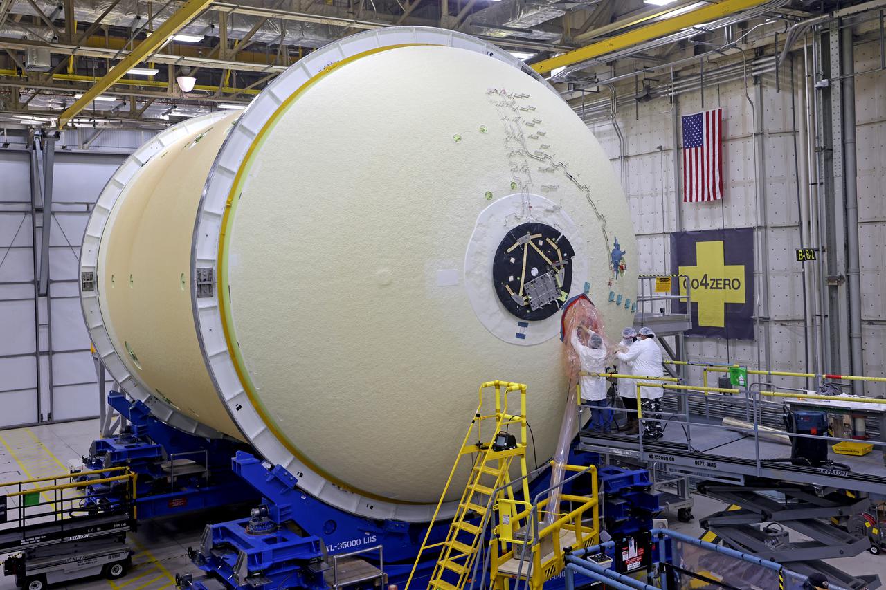 This image shows technicians and engineers preparing to move the liquid oxygen tank (LOX) into position as they continue the process of the forward join on the core stage of NASA’s Space Launch System rocket for Artemis II, the first crewed mission of NASA’s Artemis program at NASA’s Michoud Assembly Facility. The forward join connects the forward skirt, the liquid oxygen tank (LOX) and the intertank structures to form the top part of the SLS rocket’s core stage. Now, NASA and Boeing, the SLS prime contractor, will continue to integrate various systems inside the forward part of the core stage and prepare for structural joining of the liquid hydrogen tank and engine section to form the bottom of the stage.  Together with its four RS-25 engines, the rocket’s massive 212-foot-tall core stage — the largest stage NASA has ever built — and its twin solid rocket boosters will produce 8.8 million pounds of thrust to send NASA’s Orion spacecraft, astronauts and supplies beyond Earth’s orbit to the Moon and, ultimately, Mars. Offering more payload mass, volume capability and energy to speed missions through space, the SLS rocket, along with NASA’s Gateway in lunar orbit, the Human Landing System, and Orion spacecraft, is part of NASA’s backbone for deep space exploration and the Artemis lunar program. No other rocket is capable of carrying astronauts in Orion around the Moon in a single mission. Image credit: NASA/Michael DeMocker 