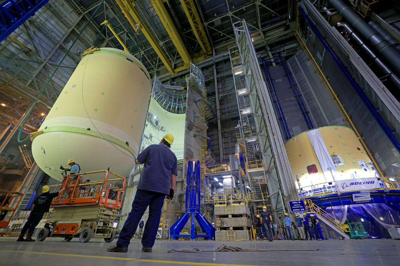 This image shows technicians and engineers move and connect the liquid oxygen tank (LOX) to the intertank as they continue the process of the forward join on the core stage of NASA’s Space Launch System rocket for Artemis II, the first crewed mission of NASA’s Artemis program at NASA’s Michoud Assembly Facility. The forward join connects the forward skirt, the liquid oxygen tank (LOX) and the intertank structures to form the top part of the SLS rocket’s core stage. Now, NASA and Boeing, the SLS prime contractor, will continue to integrate various systems inside the forward part of the core stage and prepare for structural joining of the liquid hydrogen tank and engine section to form the bottom of the stage.  Together with its four RS-25 engines, the rocket’s massive 212-foot-tall core stage — the largest stage NASA has ever built — and its twin solid rocket boosters will produce 8.8 million pounds of thrust to send NASA’s Orion spacecraft, astronauts and supplies beyond Earth’s orbit to the Moon and, ultimately, Mars. Offering more payload mass, volume capability and energy to speed missions through space, the SLS rocket, along with NASA’s Gateway in lunar orbit, the Human Landing System, and Orion spacecraft, is part of NASA’s backbone for deep space exploration and the Artemis lunar program. No other rocket is capable of carrying astronauts in Orion around the Moon in a single mission. Image credit: NASA/Michael DeMocker 