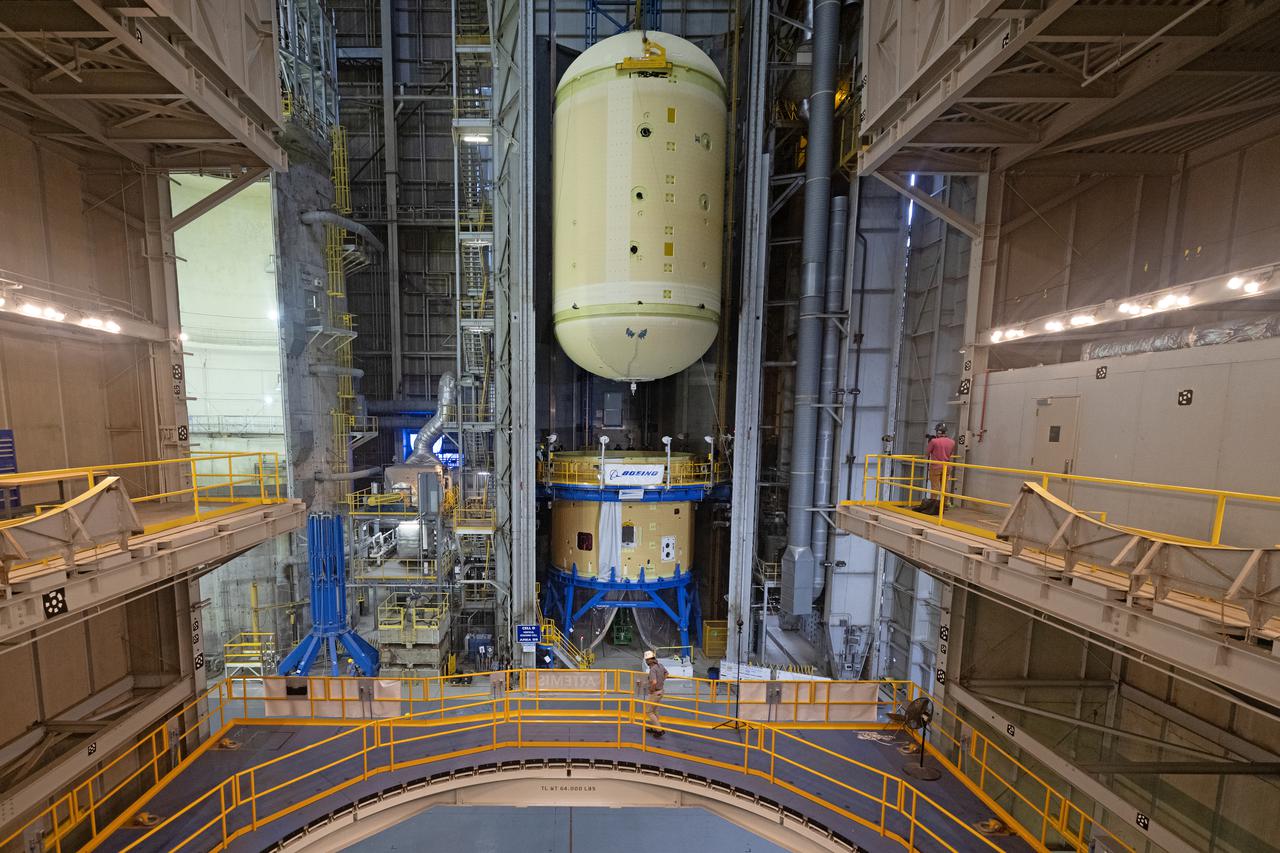 This image shows technicians and engineers move and connect the liquid oxygen tank (LOX) to the intertank as they continue the process of the forward join on the core stage of NASA’s Space Launch System rocket for Artemis II, the first crewed mission of NASA’s Artemis program at NASA’s Michoud Assembly Facility. The forward join connects the forward skirt, the liquid oxygen tank (LOX) and the intertank structures to form the top part of the SLS rocket’s core stage. Now, NASA and Boeing, the SLS prime contractor, will continue to integrate various systems inside the forward part of the core stage and prepare for structural joining of the liquid hydrogen tank and engine section to form the bottom of the stage.  Together with its four RS-25 engines, the rocket’s massive 212-foot-tall core stage — the largest stage NASA has ever built — and its twin solid rocket boosters will produce 8.8 million pounds of thrust to send NASA’s Orion spacecraft, astronauts and supplies beyond Earth’s orbit to the Moon and, ultimately, Mars. Offering more payload mass, volume capability and energy to speed missions through space, the SLS rocket, along with NASA’s Gateway in lunar orbit, the Human Landing System, and Orion spacecraft, is part of NASA’s backbone for deep space exploration and the Artemis lunar program. No other rocket is capable of carrying astronauts in Orion around the Moon in a single mission. Image credit: NASA/Michael DeMocker 