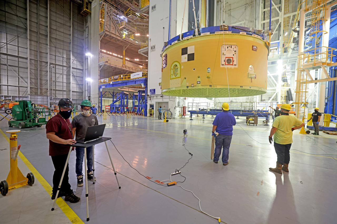 This image shows technicians and engineers preparing to movie and connect the forward skirt to the liquid oxygen tank (LOX) as they continue the process of the forward join on the core stage of NASA’s Space Launch System rocket for Artemis II, the first crewed mission of NASA’s Artemis program at NASA’s Michoud Assembly Facility. The forward join connects the forward skirt, the liquid oxygen tank (LOX) and the intertank structures to form the top part of the SLS rocket’s core stage. Now, NASA and Boeing, the SLS prime contractor, will continue to integrate various systems inside the forward part of the core stage and prepare for structural joining of the liquid hydrogen tank and engine section to form the bottom of the stage.  Together with its four RS-25 engines, the rocket’s massive 212-foot-tall core stage — the largest stage NASA has ever built — and its twin solid rocket boosters will produce 8.8 million pounds of thrust to send NASA’s Orion spacecraft, astronauts and supplies beyond Earth’s orbit to the Moon and, ultimately, Mars. Offering more payload mass, volume capability and energy to speed missions through space, the SLS rocket, along with NASA’s Gateway in lunar orbit, the Human Landing System, and Orion spacecraft, is part of NASA’s backbone for deep space exploration and the Artemis lunar program. No other rocket is capable of carrying astronauts in Orion around the Moon in a single mission. Image credit: NASA/Michael DeMocker 