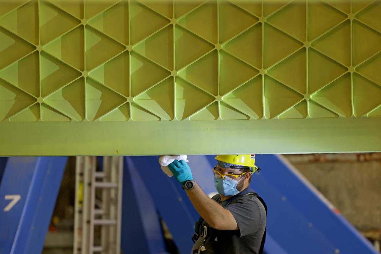 NASA’s Space Launch System (SLS) team fully stacked three hardware elements together May 24 to form the top of the rocket’s core stage for the Artemis II mission. NASA and core stage prime contractor Boeing connected the forward skirt with the liquid oxygen tank and intertank flight hardware inside an assembly area at NASA’s Michoud Assembly Facility in New Orleans. Teams had previously stacked the liquid oxygen tank and intertank on April 28. The joining of the three structures together is the first major assembly of core stage hardware for Artemis II, the first crewed Artemis mission and second flight of the SLS rocket. Next, technicians will work to complete outfitting and integrating the systems within the upper structure.   At 66 feet tall, the upper part of the stage is just a fraction of the entire core stage. The fully-assembled, 212-foot-tall rocket stage consists of five hardware elements, including two liquid propellant tanks and four RS-25 engines. The liquid oxygen tank in the upper portion of the stage will hold 196,000 gallons of liquid oxygen cooled to minus 297 degrees Fahrenheit. Meanwhile, the forward skirt and intertank house avionics, flight computer, and electronic systems for the rocket stage. Together, the core stage and its four RS-25 engines will provide more than 2 million pounds of thrust to help send Artemis II astronauts beyond Earth’s orbit to lunar orbit.   With Artemis, NASA will land the first woman and the first person of color on the Moon and establish sustainable exploration in preparation for missions to Mars. SLS and NASA’s Orion spacecraft, along with the commercial human landing system and the Gateway in orbit around the Moon, are NASA’s backbone for deep space exploration. SLS is the only rocket that can send Orion, astronauts, and supplies to the Moon in a single mission. Image credit: NASA/Michael DeMocker