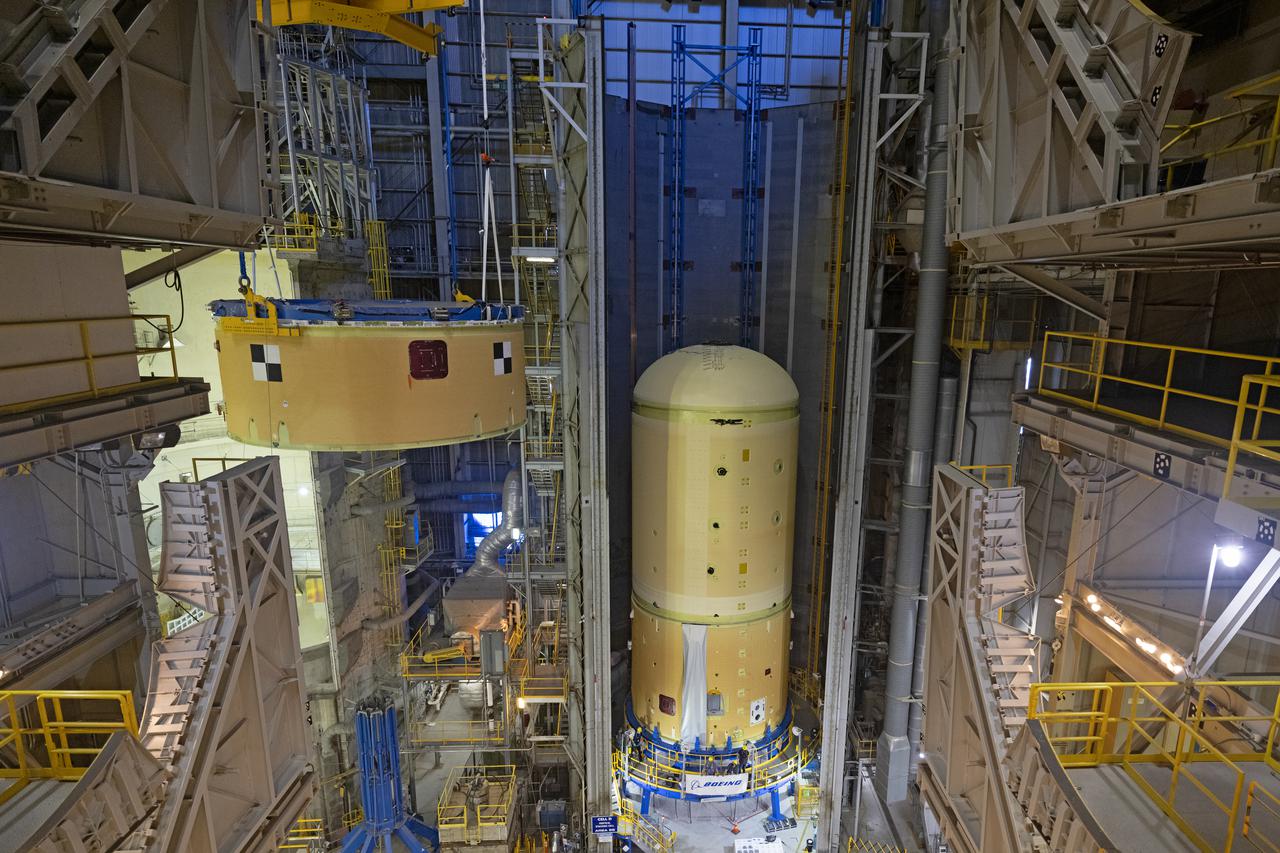 NASA’s Space Launch System (SLS) team fully stacked three hardware elements together May 24 to form the top of the rocket’s core stage for the Artemis II mission. NASA and core stage prime contractor Boeing connected the forward skirt with the liquid oxygen tank and intertank flight hardware inside an assembly area at NASA’s Michoud Assembly Facility in New Orleans. Teams had previously stacked the liquid oxygen tank and intertank on April 28. The joining of the three structures together is the first major assembly of core stage hardware for Artemis II, the first crewed Artemis mission and second flight of the SLS rocket. Next, technicians will work to complete outfitting and integrating the systems within the upper structure.   At 66 feet tall, the upper part of the stage is just a fraction of the entire core stage. The fully-assembled, 212-foot-tall rocket stage consists of five hardware elements, including two liquid propellant tanks and four RS-25 engines. The liquid oxygen tank in the upper portion of the stage will hold 196,000 gallons of liquid oxygen cooled to minus 297 degrees Fahrenheit. Meanwhile, the forward skirt and intertank house avionics, flight computer, and electronic systems for the rocket stage. Together, the core stage and its four RS-25 engines will provide more than 2 million pounds of thrust to help send Artemis II astronauts beyond Earth’s orbit to lunar orbit.   With Artemis, NASA will land the first woman and the first person of color on the Moon and establish sustainable exploration in preparation for missions to Mars. SLS and NASA’s Orion spacecraft, along with the commercial human landing system and the Gateway in orbit around the Moon, are NASA’s backbone for deep space exploration. SLS is the only rocket that can send Orion, astronauts, and supplies to the Moon in a single mission. Image credit: NASA/Michael DeMocker