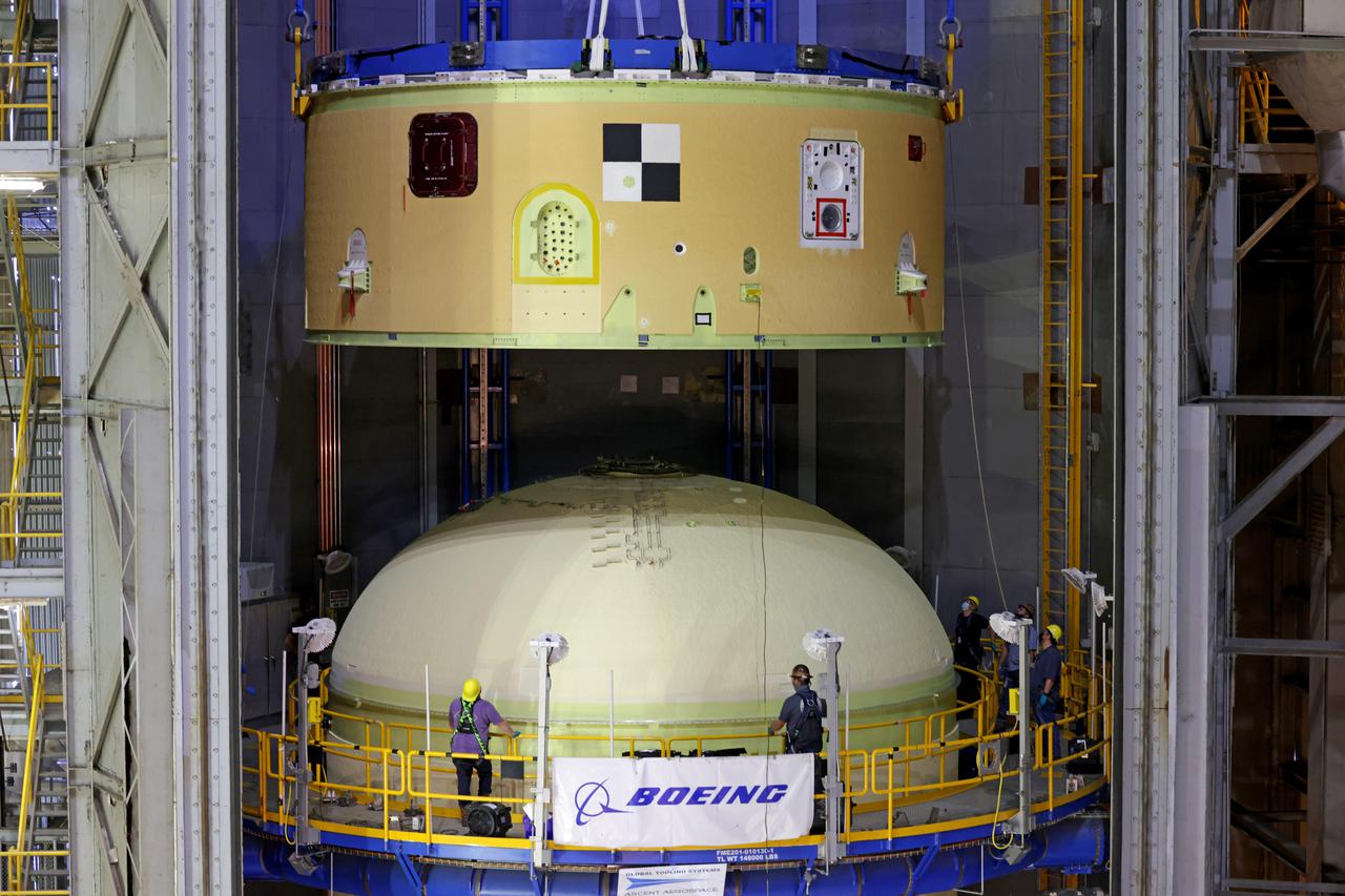 This image shows technicians and engineers moving and connecting the forward skirt to the liquid oxygen tank (LOX) as they continue the process of the forward join on the core stage of NASA’s Space Launch System rocket for Artemis II, the first crewed mission of NASA’s Artemis program at NASA’s Michoud Assembly Facility. The forward join connects the forward skirt, the liquid oxygen tank (LOX) and the intertank structures to form the top part of the SLS rocket’s core stage. Now, NASA and Boeing, the SLS prime contractor, will continue to integrate various systems inside the forward part of the core stage and prepare for structural joining of the liquid hydrogen tank and engine section to form the bottom of the stage.  Together with its four RS-25 engines, the rocket’s massive 212-foot-tall core stage — the largest stage NASA has ever built — and its twin solid rocket boosters will produce 8.8 million pounds of thrust to send NASA’s Orion spacecraft, astronauts and supplies beyond Earth’s orbit to the Moon and, ultimately, Mars. Offering more payload mass, volume capability and energy to speed missions through space, the SLS rocket, along with NASA’s Gateway in lunar orbit, the Human Landing System, and Orion spacecraft, is part of NASA’s backbone for deep space exploration and the Artemis lunar program. No other rocket is capable of carrying astronauts in Orion around the Moon in a single mission. Image credit: NASA/Michael DeMocker 