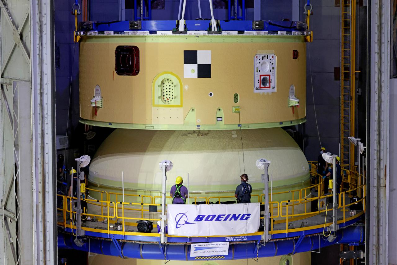 NASA’s Space Launch System (SLS) team fully stacked three hardware elements together May 24 to form the top of the rocket’s core stage for the Artemis II mission. NASA and core stage prime contractor Boeing connected the forward skirt with the liquid oxygen tank and intertank flight hardware inside an assembly area at NASA’s Michoud Assembly Facility in New Orleans. Teams had previously stacked the liquid oxygen tank and intertank on April 28. The joining of the three structures together is the first major assembly of core stage hardware for Artemis II, the first crewed Artemis mission and second flight of the SLS rocket. Next, technicians will work to complete outfitting and integrating the systems within the upper structure.   At 66 feet tall, the upper part of the stage is just a fraction of the entire core stage. The fully-assembled, 212-foot-tall rocket stage consists of five hardware elements, including two liquid propellant tanks and four RS-25 engines. The liquid oxygen tank in the upper portion of the stage will hold 196,000 gallons of liquid oxygen cooled to minus 297 degrees Fahrenheit. Meanwhile, the forward skirt and intertank house avionics, flight computer, and electronic systems for the rocket stage. Together, the core stage and its four RS-25 engines will provide more than 2 million pounds of thrust to help send Artemis II astronauts beyond Earth’s orbit to lunar orbit.   With Artemis, NASA will land the first woman and the first person of color on the Moon and establish sustainable exploration in preparation for missions to Mars. SLS and NASA’s Orion spacecraft, along with the commercial human landing system and the Gateway in orbit around the Moon, are NASA’s backbone for deep space exploration. SLS is the only rocket that can send Orion, astronauts, and supplies to the Moon in a single mission. Image credit: NASA/Michael DeMocker