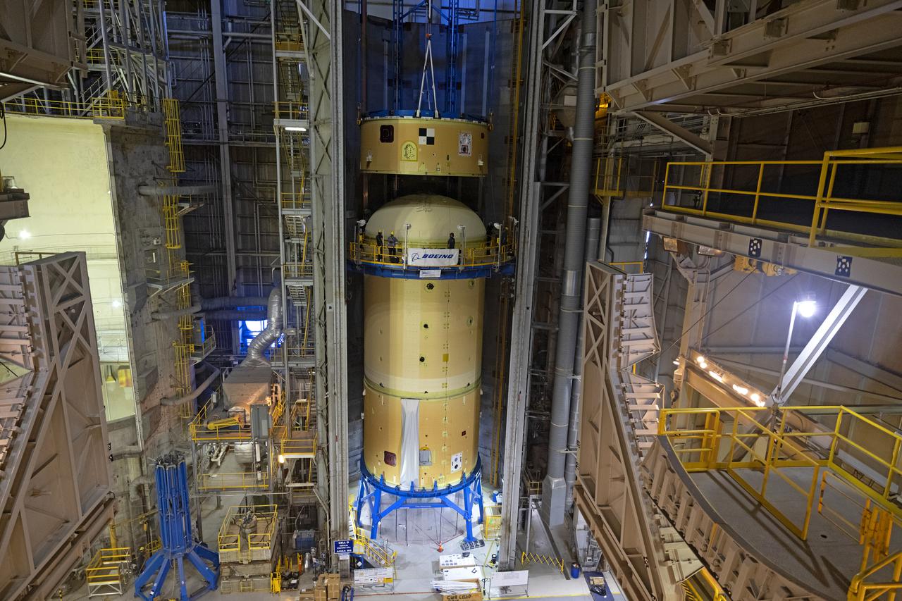 NASA’s Space Launch System (SLS) team fully stacked three hardware elements together May 24 to form the top of the rocket’s core stage for the Artemis II mission. NASA and core stage prime contractor Boeing connected the forward skirt with the liquid oxygen tank and intertank flight hardware inside an assembly area at NASA’s Michoud Assembly Facility in New Orleans. Teams had previously stacked the liquid oxygen tank and intertank on April 28. The joining of the three structures together is the first major assembly of core stage hardware for Artemis II, the first crewed Artemis mission and second flight of the SLS rocket. Next, technicians will work to complete outfitting and integrating the systems within the upper structure.   At 66 feet tall, the upper part of the stage is just a fraction of the entire core stage. The fully-assembled, 212-foot-tall rocket stage consists of five hardware elements, including two liquid propellant tanks and four RS-25 engines. The liquid oxygen tank in the upper portion of the stage will hold 196,000 gallons of liquid oxygen cooled to minus 297 degrees Fahrenheit. Meanwhile, the forward skirt and intertank house avionics, flight computer, and electronic systems for the rocket stage. Together, the core stage and its four RS-25 engines will provide more than 2 million pounds of thrust to help send Artemis II astronauts beyond Earth’s orbit to lunar orbit.   With Artemis, NASA will land the first woman and the first person of color on the Moon and establish sustainable exploration in preparation for missions to Mars. SLS and NASA’s Orion spacecraft, along with the commercial human landing system and the Gateway in orbit around the Moon, are NASA’s backbone for deep space exploration. SLS is the only rocket that can send Orion, astronauts, and supplies to the Moon in a single mission. Image credit: NASA/Michael DeMocker
