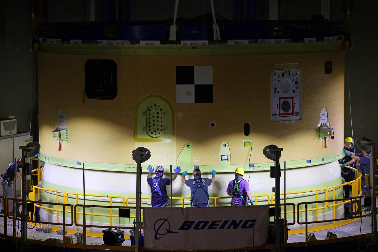 NASA’s Space Launch System (SLS) team fully stacked three hardware elements together May 24 to form the top of the rocket’s core stage for the Artemis II mission. NASA and core stage prime contractor Boeing connected the forward skirt with the liquid oxygen tank and intertank flight hardware inside an assembly area at NASA’s Michoud Assembly Facility in New Orleans. Teams had previously stacked the liquid oxygen tank and intertank on April 28. The joining of the three structures together is the first major assembly of core stage hardware for Artemis II, the first crewed Artemis mission and second flight of the SLS rocket. Next, technicians will work to complete outfitting and integrating the systems within the upper structure.   At 66 feet tall, the upper part of the stage is just a fraction of the entire core stage. The fully-assembled, 212-foot-tall rocket stage consists of five hardware elements, including two liquid propellant tanks and four RS-25 engines. The liquid oxygen tank in the upper portion of the stage will hold 196,000 gallons of liquid oxygen cooled to minus 297 degrees Fahrenheit. Meanwhile, the forward skirt and intertank house avionics, flight computer, and electronic systems for the rocket stage. Together, the core stage and its four RS-25 engines will provide more than 2 million pounds of thrust to help send Artemis II astronauts beyond Earth’s orbit to lunar orbit.   With Artemis, NASA will land the first woman and the first person of color on the Moon and establish sustainable exploration in preparation for missions to Mars. SLS and NASA’s Orion spacecraft, along with the commercial human landing system and the Gateway in orbit around the Moon, are NASA’s backbone for deep space exploration. SLS is the only rocket that can send Orion, astronauts, and supplies to the Moon in a single mission.  Image credit: NASA/Michael DeMocker