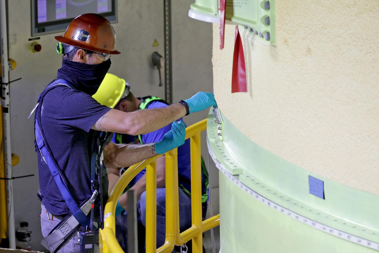 NASA’s Space Launch System (SLS) team fully stacked three hardware elements together May 24 to form the top of the rocket’s core stage for the Artemis II mission. NASA and core stage prime contractor Boeing connected the forward skirt with the liquid oxygen tank and intertank flight hardware inside an assembly area at NASA’s Michoud Assembly Facility in New Orleans. Teams had previously stacked the liquid oxygen tank and intertank on April 28. The joining of the three structures together is the first major assembly of core stage hardware for Artemis II, the first crewed Artemis mission and second flight of the SLS rocket. Next, technicians will work to complete outfitting and integrating the systems within the upper structure.   At 66 feet tall, the upper part of the stage is just a fraction of the entire core stage. The fully-assembled, 212-foot-tall rocket stage consists of five hardware elements, including two liquid propellant tanks and four RS-25 engines. The liquid oxygen tank in the upper portion of the stage will hold 196,000 gallons of liquid oxygen cooled to minus 297 degrees Fahrenheit. Meanwhile, the forward skirt and intertank house avionics, flight computer, and electronic systems for the rocket stage. Together, the core stage and its four RS-25 engines will provide more than 2 million pounds of thrust to help send Artemis II astronauts beyond Earth’s orbit to lunar orbit.   With Artemis, NASA will land the first woman and the first person of color on the Moon and establish sustainable exploration in preparation for missions to Mars. SLS and NASA’s Orion spacecraft, along with the commercial human landing system and the Gateway in orbit around the Moon, are NASA’s backbone for deep space exploration. SLS is the only rocket that can send Orion, astronauts, and supplies to the Moon in a single mission. Image credit: NASA/Michael DeMocker