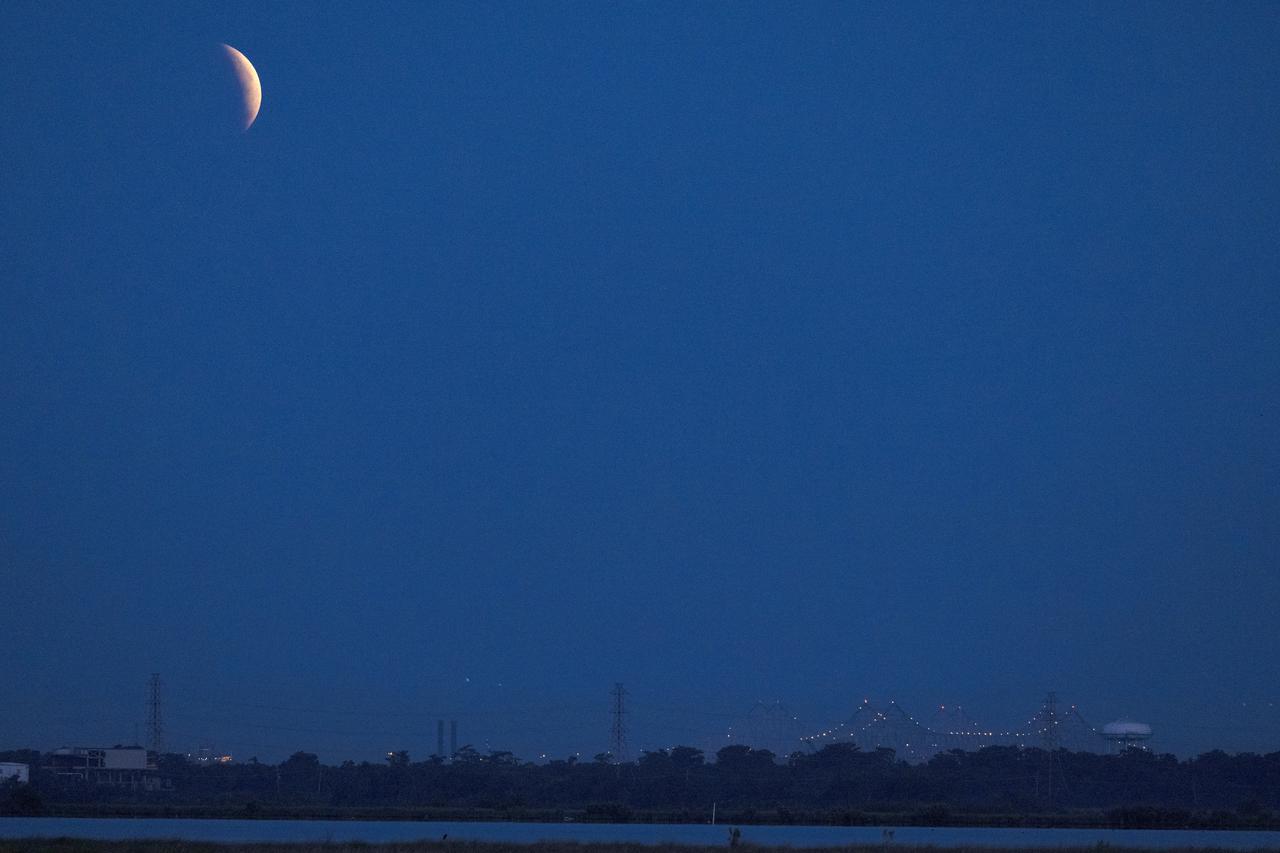 The eclipse of the Super Flower Blood Moon over Bayou Bienvenue with the New Orleans Crescent City Connection in the distance early Wednesday morning, May 26, 2021. Image credit: NASA/Michael DeMocker