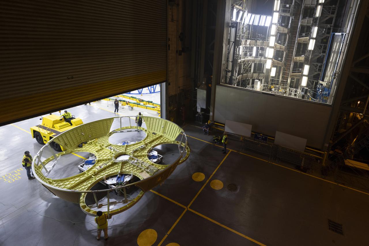 Technicians and engineers move the boat-tail structure for the core stage of NASA’s Space Launch System’s (SLS) rocket for Artemis II, the first crewed mission of NASA’s Artemis program at NASA’s Michoud Assembly Facility. The boat-tail, a fairing-like cover that attaches to the engine section on the bottom of the core stage, protects and covers most of the four RS-25 engines’ critical systems. Together with its four RS-25 engines, the rocket’s massive 212-foot-tall core stage — the largest stage NASA has ever built — and its twin solid rocket boosters will produce 8.8 million pounds of thrust to send NASA’s Orion spacecraft, astronauts and supplies beyond Earth’s orbit to the Moon and, ultimately, Mars. Offering more payload mass, volume capability and energy to speed missions through space, the SLS rocket, along with NASA’s Gateway in lunar orbit, the Human Landing System, and Orion spacecraft, is part of NASA’s backbone for deep space exploration and the Artemis lunar program. No other rocket is capable of carrying astronauts in Orion around the Moon in a single mission. Photographed on Wednesday, June 9, 2021. Image credit: NASA/Michael DeMocker