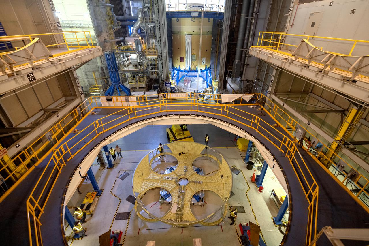 Technicians and engineers move the boat-tail structure for the core stage of NASA’s Space Launch System’s (SLS) rocket for Artemis II, the first crewed mission of NASA’s Artemis program at NASA’s Michoud Assembly Facility. The boat-tail, a fairing-like cover that attaches to the engine section on the bottom of the core stage, protects and covers most of the four RS-25 engines’ critical systems. Together with its four RS-25 engines, the rocket’s massive 212-foot-tall core stage — the largest stage NASA has ever built — and its twin solid rocket boosters will produce 8.8 million pounds of thrust to send NASA’s Orion spacecraft, astronauts and supplies beyond Earth’s orbit to the Moon and, ultimately, Mars. Offering more payload mass, volume capability and energy to speed missions through space, the SLS rocket, along with NASA’s Gateway in lunar orbit, the Human Landing System, and Orion spacecraft, is part of NASA’s backbone for deep space exploration and the Artemis lunar program. No other rocket is capable of carrying astronauts in Orion around the Moon in a single mission. Photographed on Wednesday, June 9, 2021. Image credit: NASA/Michael DeMocker