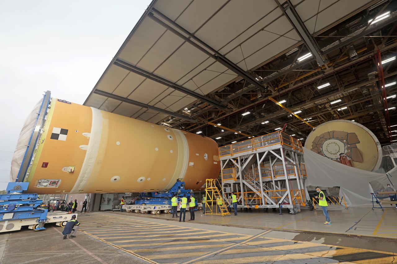 NASA has completed assembly of the upper, or forward, part of the core stage for the Space Launch System (SLS) rocket that will send the Artemis II crew on their lunar mission. Boeing, the lead core stage contractor, completed joining the forward part of the rocket, and then lifted it out of the assembly structure at NASA’s Michoud Assembly Facility in New Orleans. To construct this part of the core stage, the team first stacked three major parts of the stage—the forward skirt, the liquid oxygen tank, and the intertank. The forward skirt sits atop the rocket’s core stage, and it and the intertank are outfitted with the rocket’s flight computers and avionics systems that control SLS during launch and ascent. The liquid oxygen tank holds 196,000 gallons of liquid oxygen cooled to minus 297 degrees Fahrenheit.   The entire upper part of the stage is around 66-feet tall. The fully-assembled, 212-foot-tall rocket stage consists of five hardware elements. As the team lifted it out of the assembly area, they completed a breakover maneuver, to put the forward assembly in a horizontal position. Then, they moved it to final assembly where the Artemis II liquid hydrogen tank is also undergoing outfitting. Here, teams will connect the liquid hydrogen tank to the upper part of the rocket and complete assembly of four of the five core stage parts. The last piece to be added will be the engine section, which is currently in a separate assembly area being outfitted with propulsion systems that connect to the engines.  Image credit: NASA/Michael DeMocker