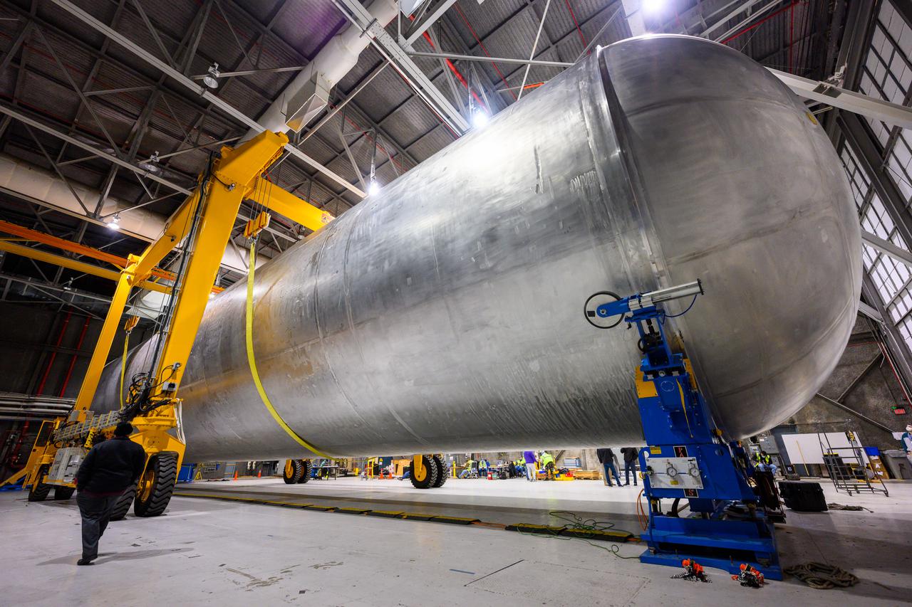 The liquid hydrogen tank that will be part of the Space Launch System rocket’s core stage is being prepared for the Artemis III mission at NASA’s Michoud Assembly Facility in New Orleans. Eventually, the tank will be connected to the engine section that will house the four RS-25 engines.  Once the aft simulator is attached, the LH2 tank undergoes non-destructive evaluation, which will test weld strength and ensure the tank is structurally sound.  The SLS core stage is made up of five unique elements: the forward skirt, liquid oxygen tank, intertank, liquid hydrogen tank, and the engine section. The tank holds 537,000 gallons of liquid hydrogen cooled to minus 432 degrees Fahrenheit and sits between the core stage’s intertank and engine section. The liquid hydrogen hardware, along with the liquid oxygen tank, will provide propellant to the four RS-25 engines at the bottom of the core stage to produce more than two million pounds of thrust to help launch the Artemis III mission to the Moon. Together with its four RS-25 engines, the rocket’s massive 212-foot-tall core stage — the largest stage NASA has ever built — and its twin solid rocket boosters will produce 8.8 million pounds of thrust to send NASA’s Orion spacecraft, astronauts and supplies beyond Earth’s orbit to the Moon.  