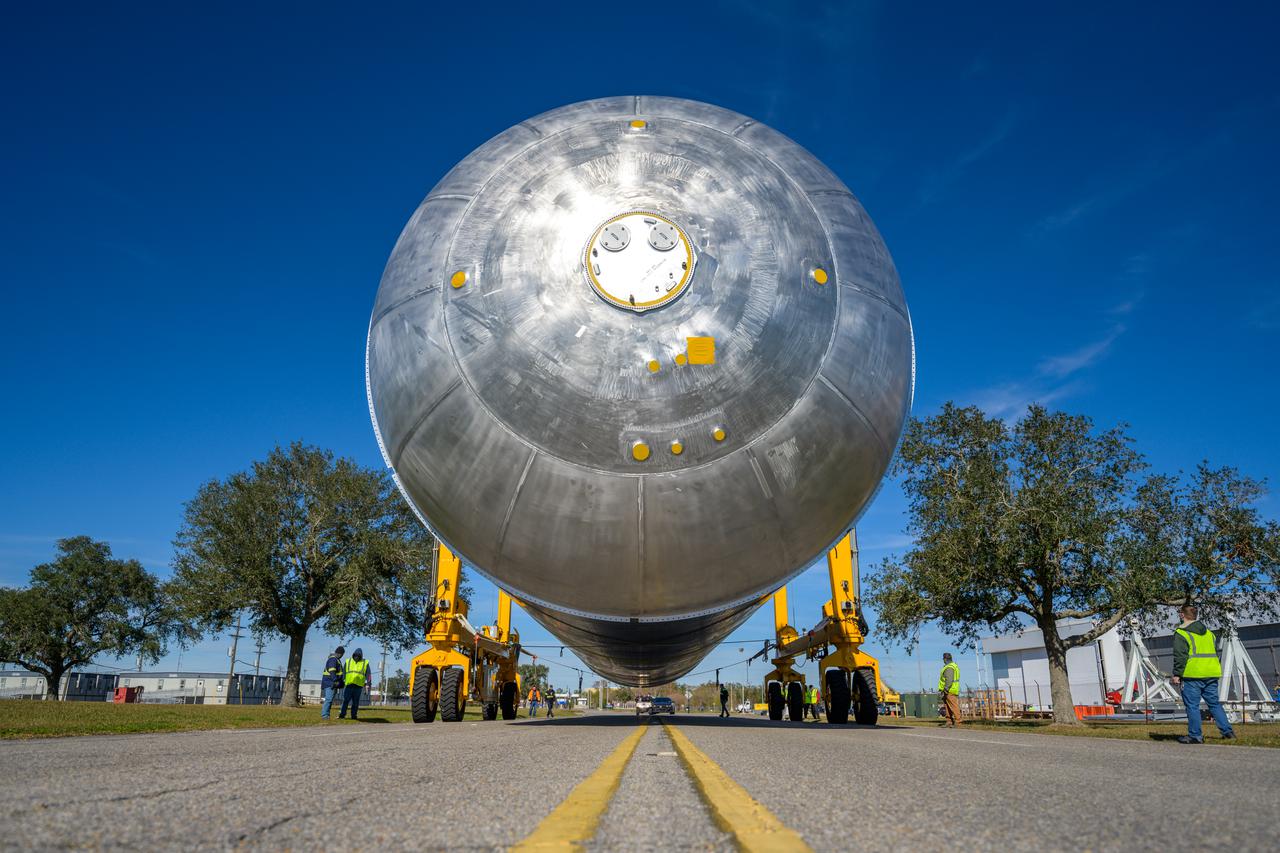 The liquid hydrogen tank that will be part of the Space Launch System rocket’s core stage is being prepared for the Artemis III mission at NASA’s Michoud Assembly Facility in New Orleans. Eventually, the tank will be connected to the engine section that will house the four RS-25 engines.  Once the aft simulator is attached, the LH2 tank undergoes non-destructive evaluation, which will test weld strength and ensure the tank is structurally sound.  The SLS core stage is made up of five unique elements: the forward skirt, liquid oxygen tank, intertank, liquid hydrogen tank, and the engine section. The tank holds 537,000 gallons of liquid hydrogen cooled to minus 432 degrees Fahrenheit and sits between the core stage’s intertank and engine section. The liquid hydrogen hardware, along with the liquid oxygen tank, will provide propellant to the four RS-25 engines at the bottom of the core stage to produce more than two million pounds of thrust to help launch the Artemis III mission to the Moon. Together with its four RS-25 engines, the rocket’s massive 212-foot-tall core stage — the largest stage NASA has ever built — and its twin solid rocket boosters will produce 8.8 million pounds of thrust to send NASA’s Orion spacecraft, astronauts and supplies beyond Earth’s orbit to the Moon.  