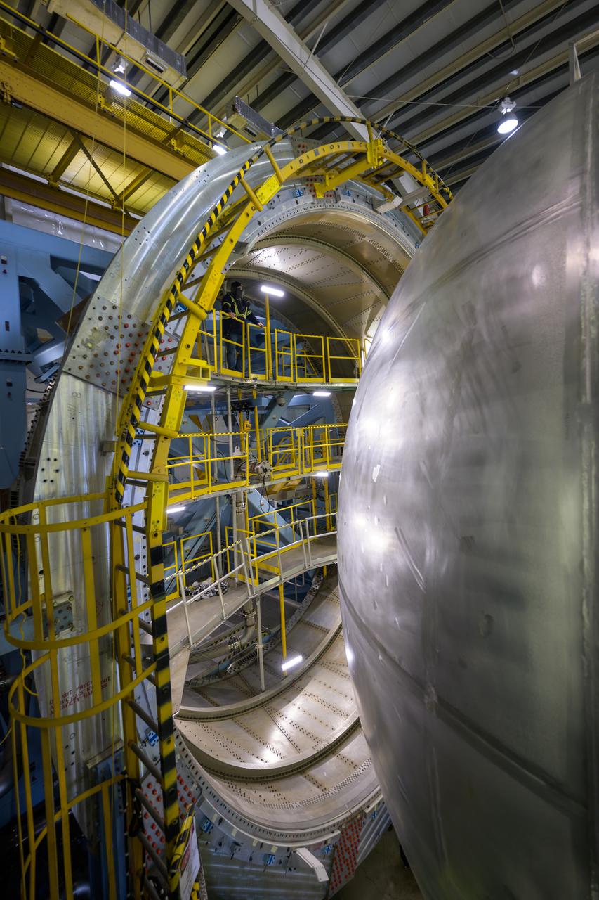 The liquid hydrogen tank that will be part of the Space Launch System rocket’s core stage is being prepared for the Artemis III mission at NASA’s Michoud Assembly Facility in New Orleans. Eventually, the tank will be connected to the engine section that will house the four RS-25 engines.  Once the aft simulator is attached, the LH2 tank undergoes non-destructive evaluation, which will test weld strength and ensure the tank is structurally sound.  The SLS core stage is made up of five unique elements: the forward skirt, liquid oxygen tank, intertank, liquid hydrogen tank, and the engine section. The tank holds 537,000 gallons of liquid hydrogen cooled to minus 432 degrees Fahrenheit and sits between the core stage’s intertank and engine section. The liquid hydrogen hardware, along with the liquid oxygen tank, will provide propellant to the four RS-25 engines at the bottom of the core stage to produce more than two million pounds of thrust to help launch the Artemis III mission to the Moon. Together with its four RS-25 engines, the rocket’s massive 212-foot-tall core stage — the largest stage NASA has ever built — and its twin solid rocket boosters will produce 8.8 million pounds of thrust to send NASA’s Orion spacecraft, astronauts and supplies beyond Earth’s orbit to the Moon.  