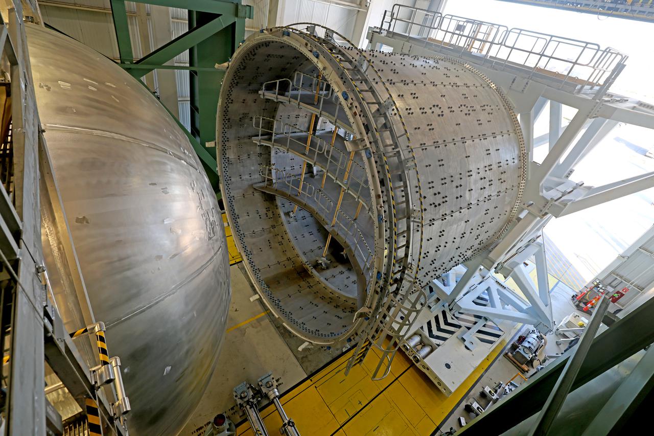 The liquid hydrogen tank that will be part of the Space Launch System rocket’s core stage is being prepared for the Artemis III mission at NASA’s Michoud Assembly Facility in New Orleans. Eventually, the tank will be connected to the engine section that will house the RS-25 engines. The engine section is still being outfitted, so for this test crews attached an engine section aft simulator during proof testing on January 27, 2022. Once the aft simulator is attached, the LH2 tank undergoes non-destructive evaluation, which will test weld strength and ensure the tank is structurally sound.  The SLS core stage is made up of five unique elements: the forward skirt, liquid oxygen tank, intertank, liquid hydrogen tank, and the engine section. The tank holds 537,000 gallons of liquid hydrogen cooled to minus 432 degrees Fahrenheit and sits between the core stage’s intertank and engine section. The liquid hydrogen hardware, along with the liquid oxygen tank, will provide propellant to the four RS-25 engines at the bottom of the core stage to produce more than two million pounds of thrust to help launch the Artemis III mission to the Moon. Together with its four RS-25 engines, the rocket’s massive 212-foot-tall core stage — the largest stage NASA has ever built — and its twin solid rocket boosters will produce 8.8 million pounds of thrust to send NASA’s Orion spacecraft, astronauts and supplies beyond Earth’s orbit to the Moon.  Image credit: NASA/Michael DeMocker 