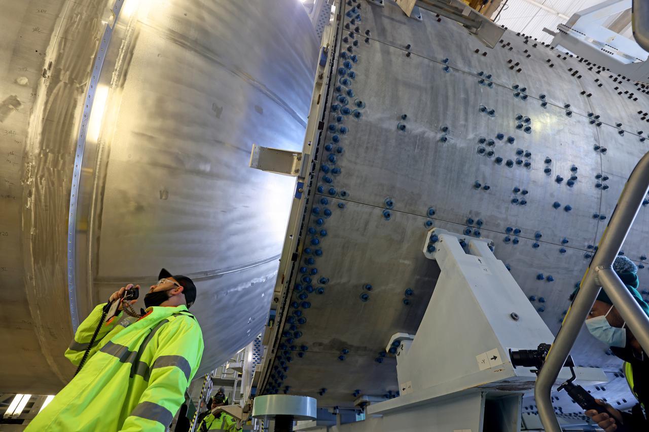 The liquid hydrogen tank that will be part of the Space Launch System rocket’s core stage is being prepared for the Artemis III mission at NASA’s Michoud Assembly Facility in New Orleans. Eventually, the tank will be connected to the engine section that will house the four RS-25 engines.  The engine section is still being outfitted, so for this test crews attached an engine section aft simulator during proof testing on January 27, 2022. Once the aft simulator is attached, the LH2 tank undergoes non-destructive evaluation, which will test weld strength and ensure the tank is structurally sound.  The SLS core stage is made up of five unique elements: the forward skirt, liquid oxygen tank, intertank, liquid hydrogen tank, and the engine section. The tank holds 537,000 gallons of liquid hydrogen cooled to minus 432 degrees Fahrenheit and sits between the core stage’s intertank and engine section. The liquid hydrogen hardware, along with the liquid oxygen tank, will provide propellant to the four RS-25 engines at the bottom of the core stage to produce more than two million pounds of thrust to help launch the Artemis III mission to the Moon. Together with its four RS-25 engines, the rocket’s massive 212-foot-tall core stage — the largest stage NASA has ever built — and its twin solid rocket boosters will produce 8.8 million pounds of thrust to send NASA’s Orion spacecraft, astronauts and supplies beyond Earth’s orbit to the Moon.  Image credit: NASA/Michael DeMocker